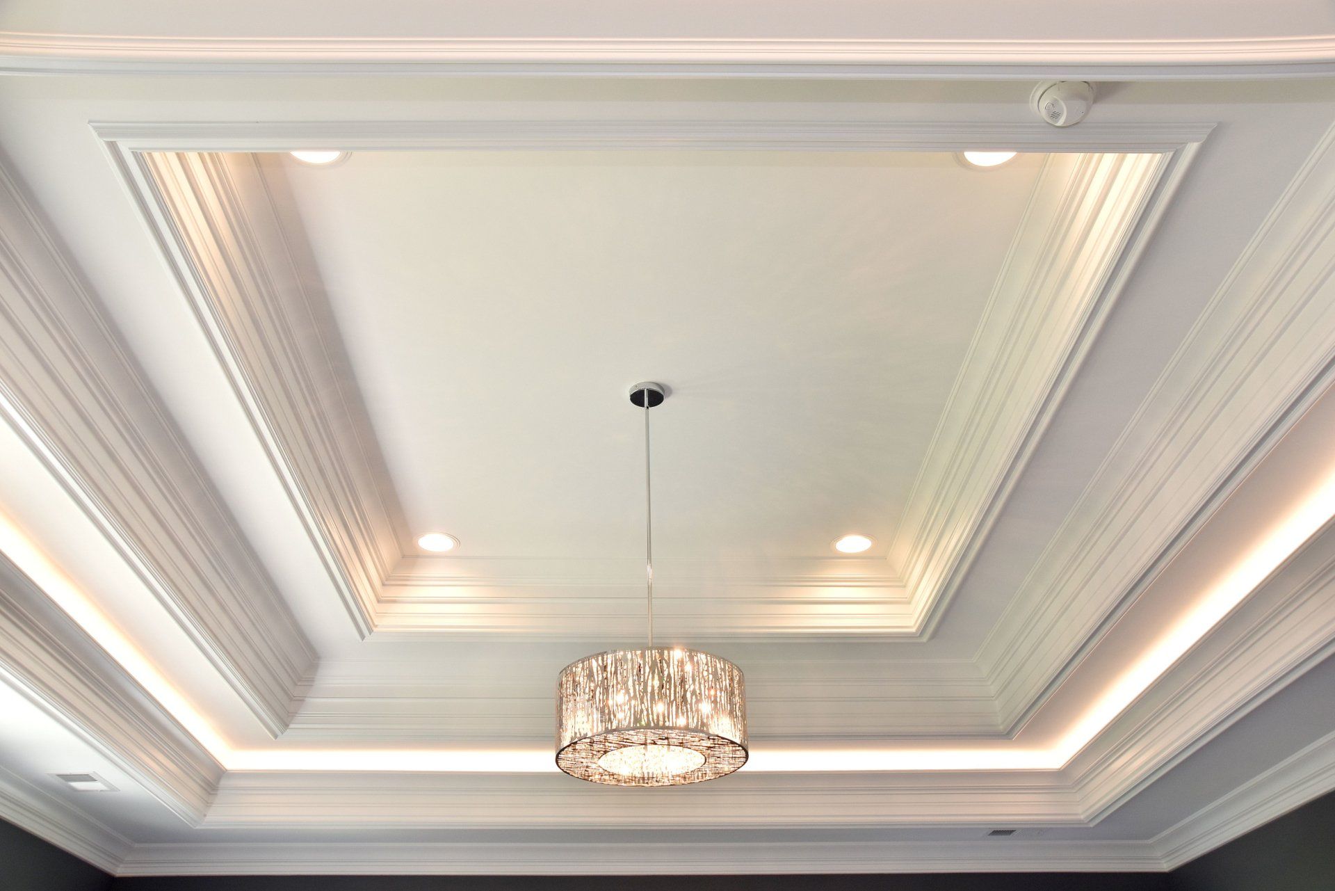 A chandelier is hanging from the ceiling of a room.