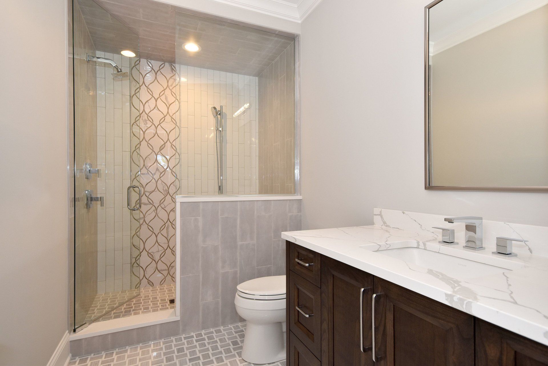 A bathroom with a toilet , sink , and walk in shower.