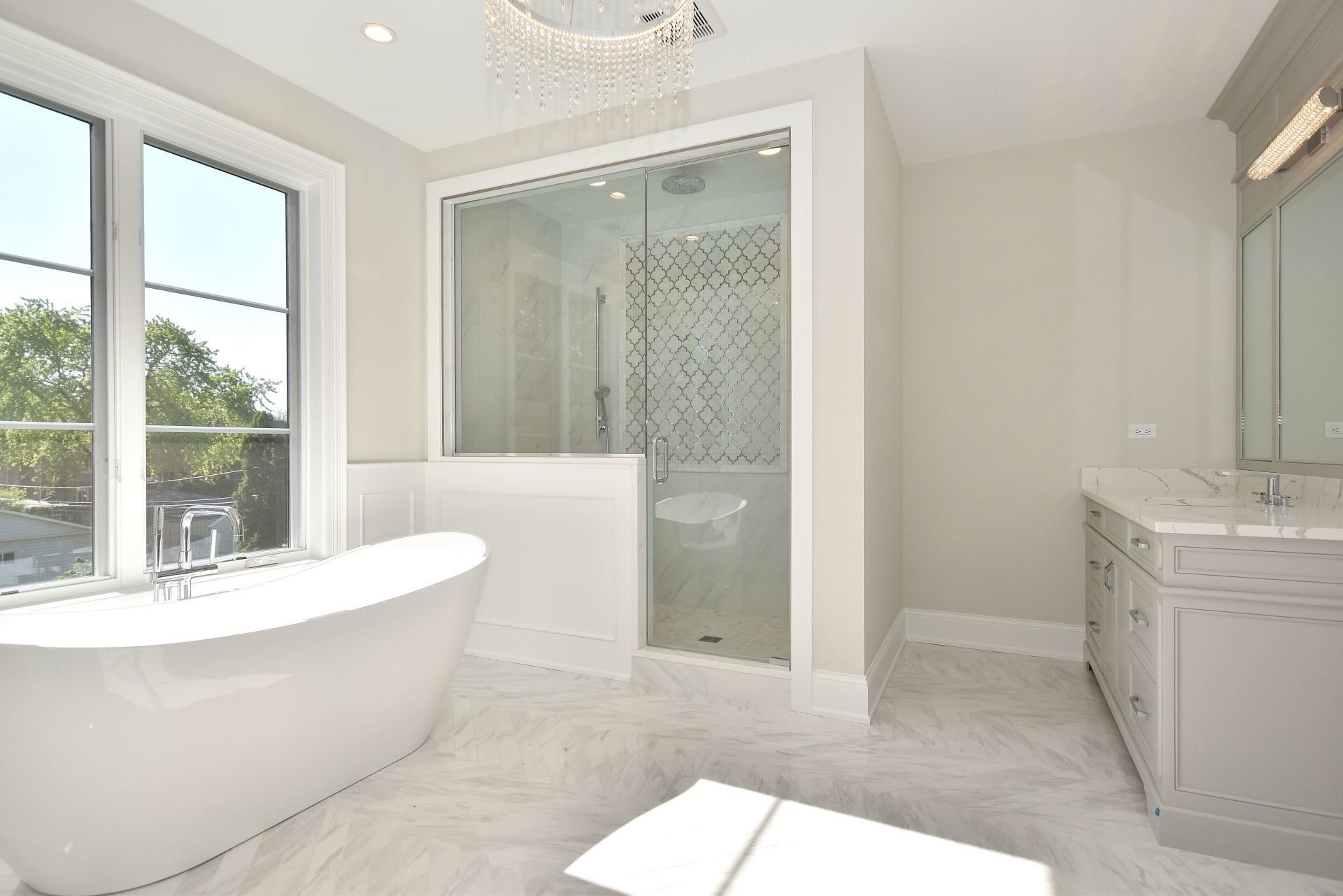 A bathroom with a bathtub , sink , and shower.