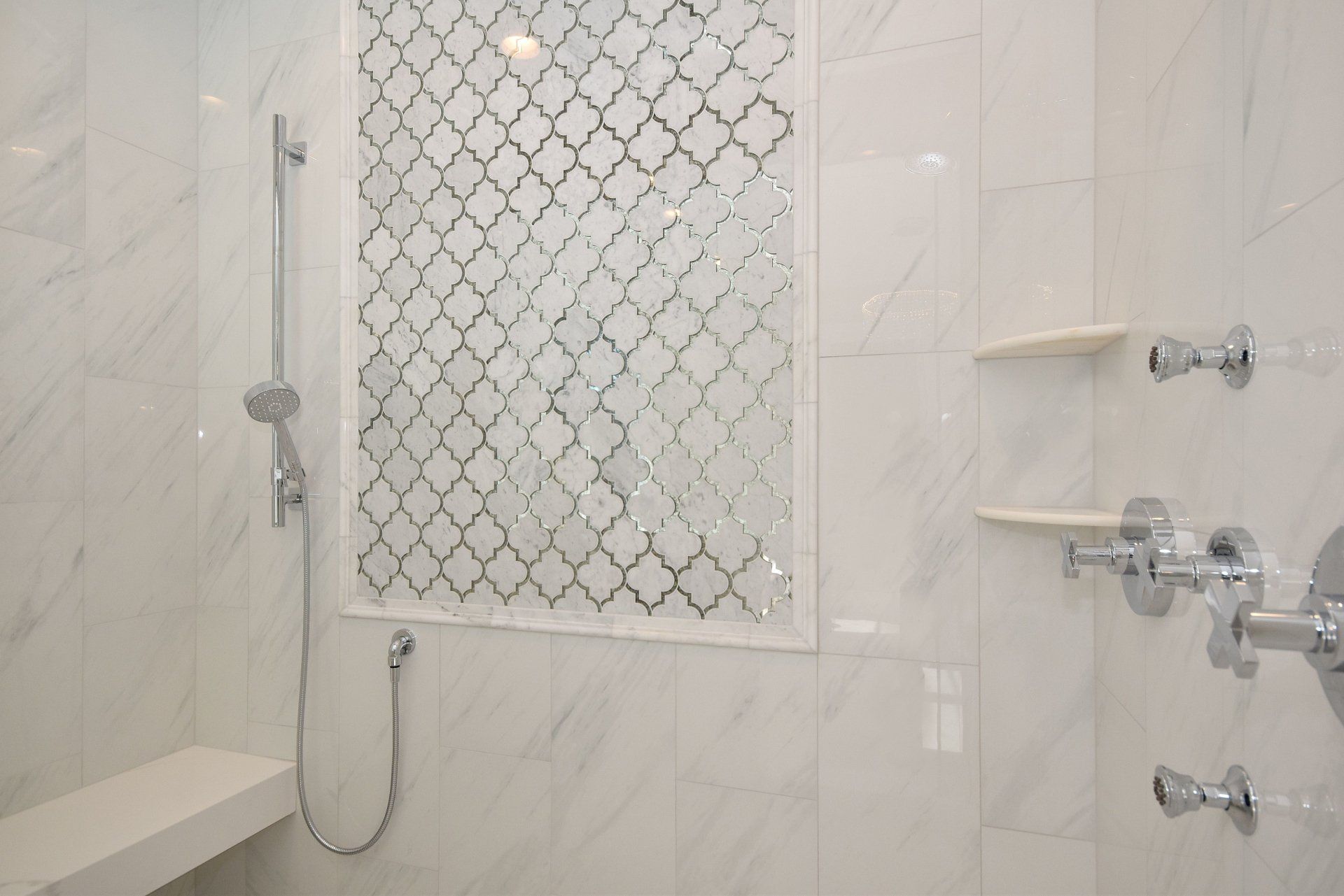 A bathroom with a shower and a bench.