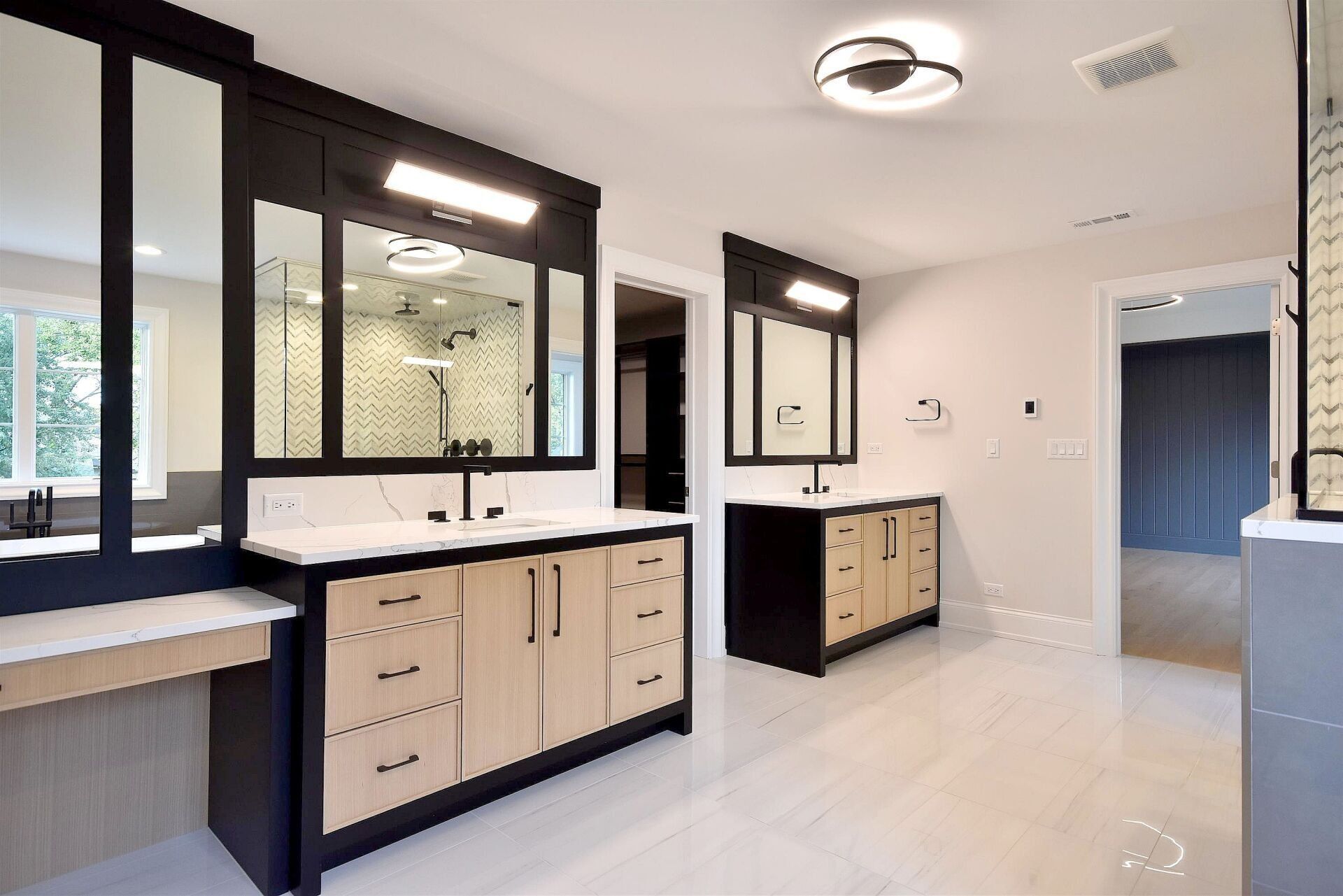 A bathroom with two sinks and two mirrors.