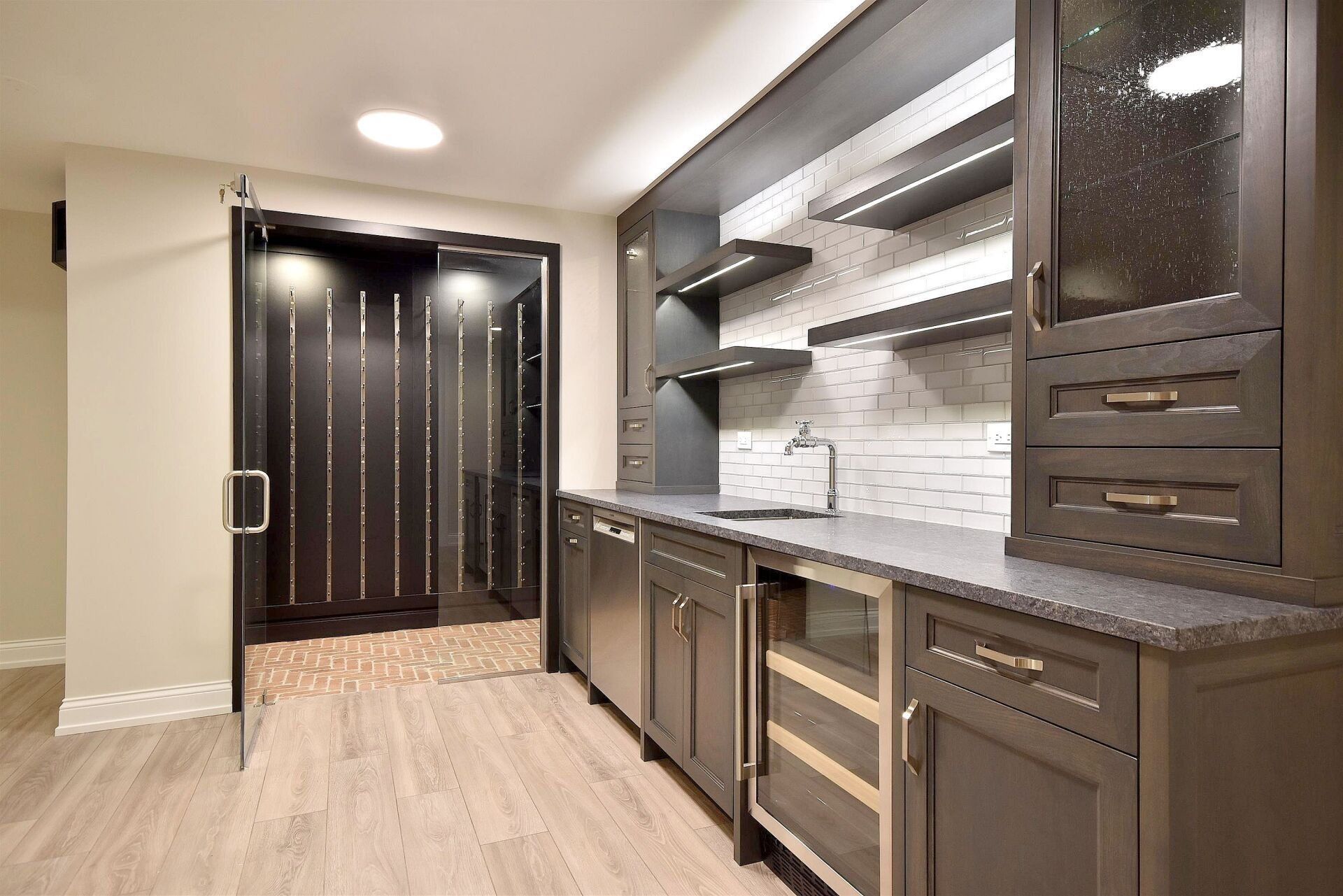 A kitchen with a lot of cabinets and a refrigerator.