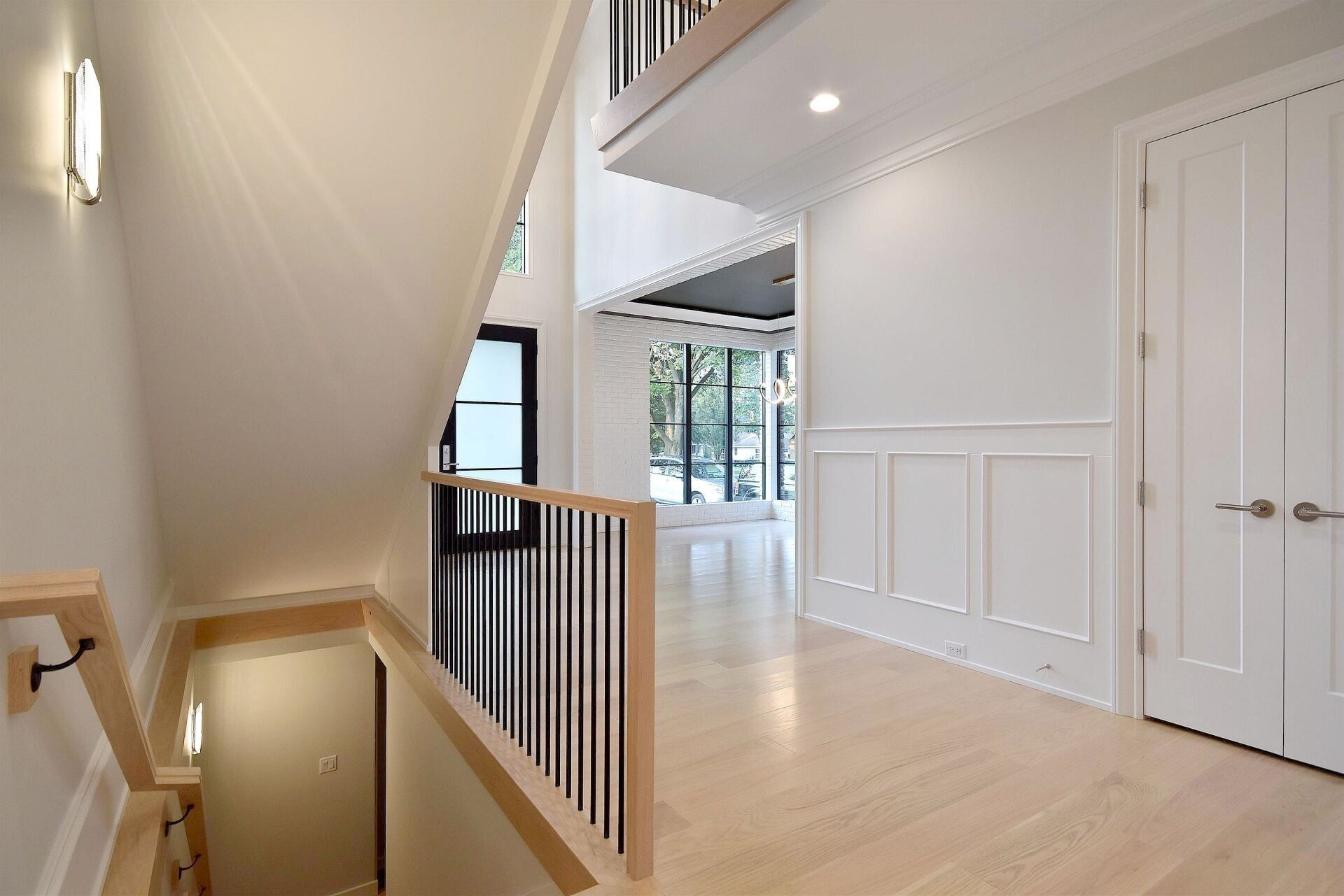 A hallway with stairs leading up to the second floor of a house.