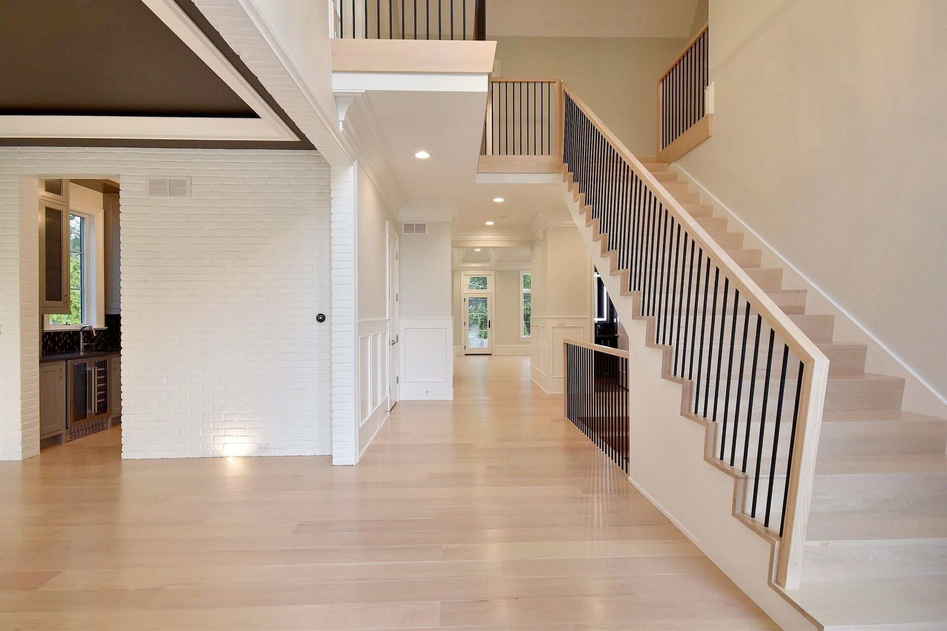 An empty hallway with stairs leading up to the second floor
