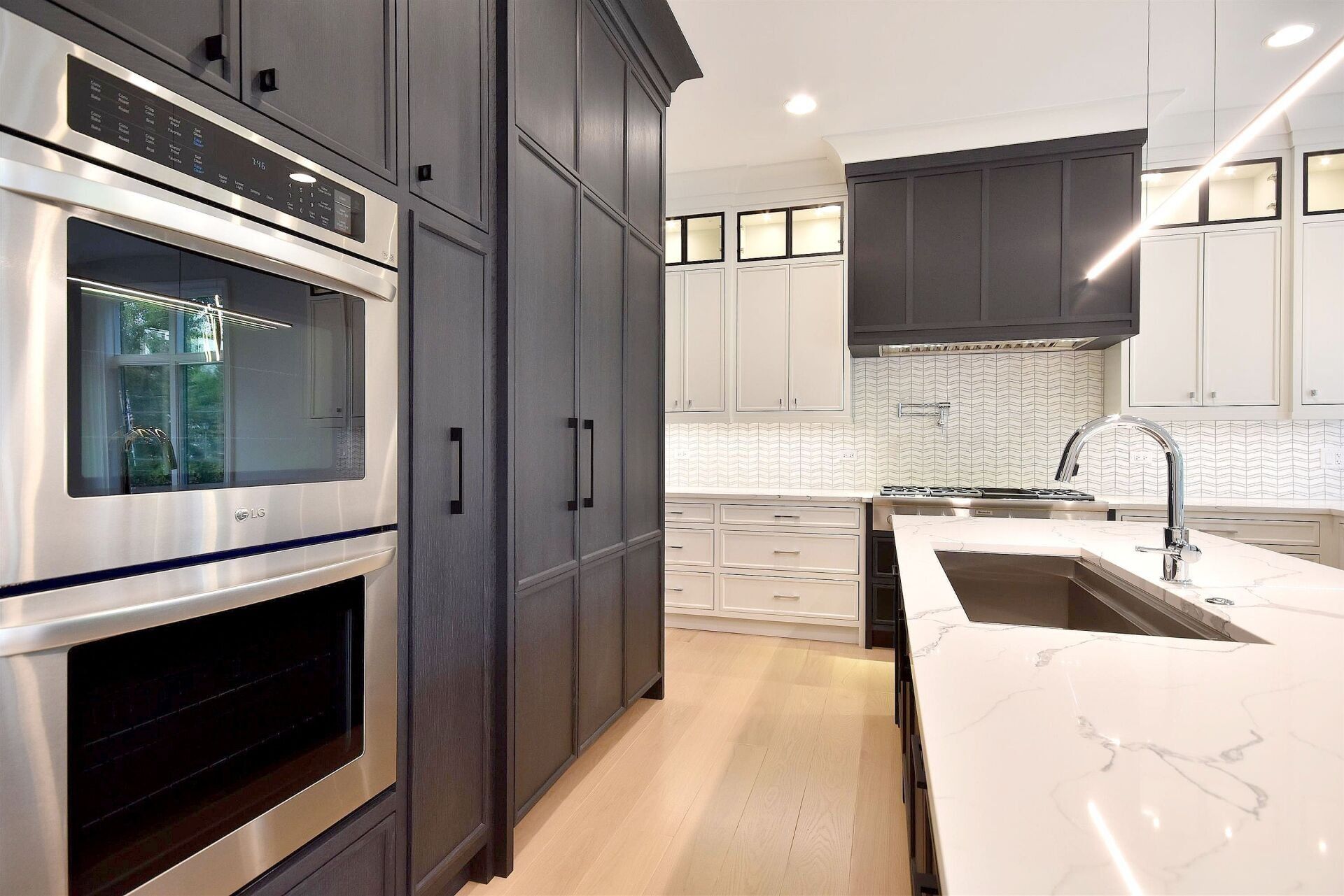 A kitchen with stainless steel appliances and a sink.