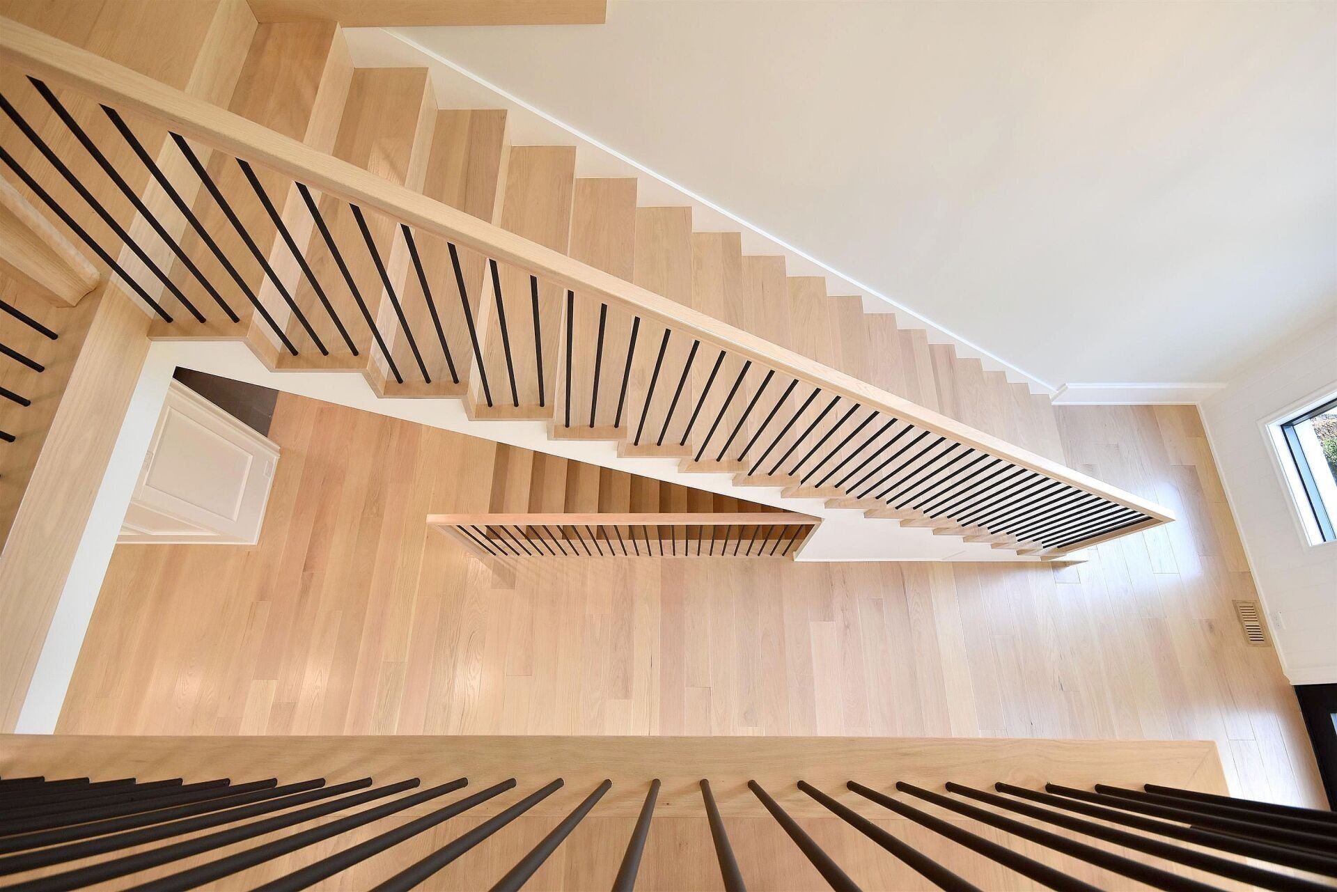 An aerial view of a wooden staircase in a house.