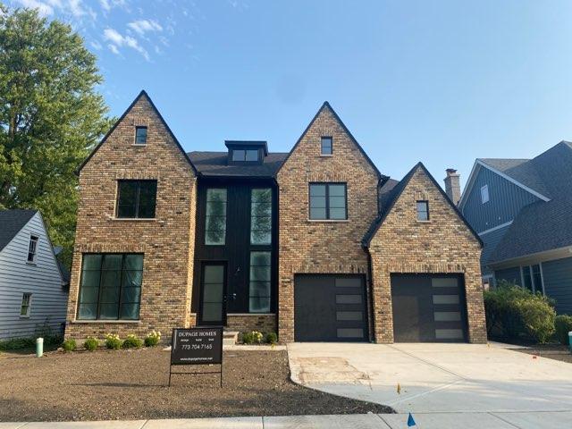 A large brick house with a black garage door