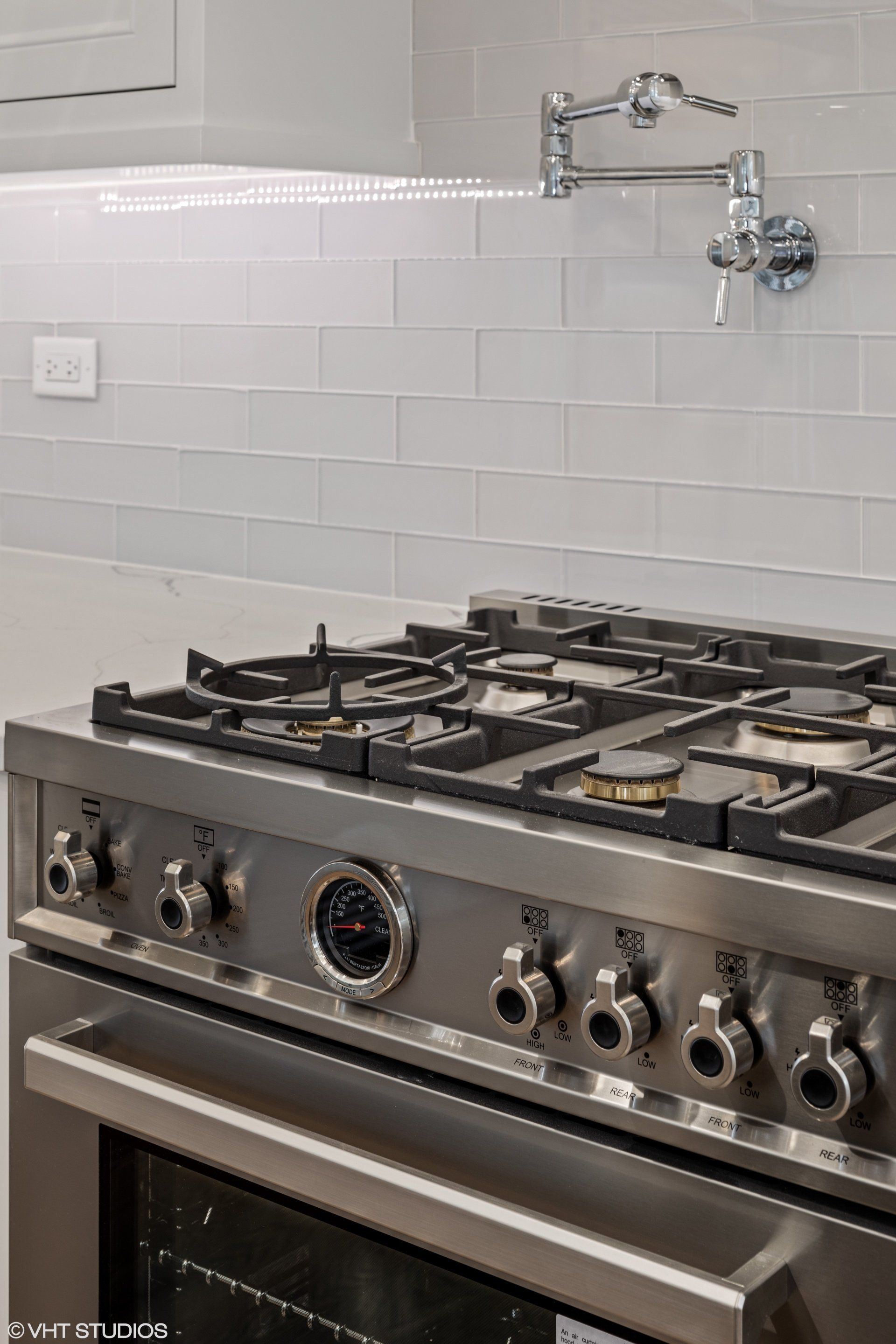 A stainless steel stove top oven is sitting on top of a stove in a kitchen.