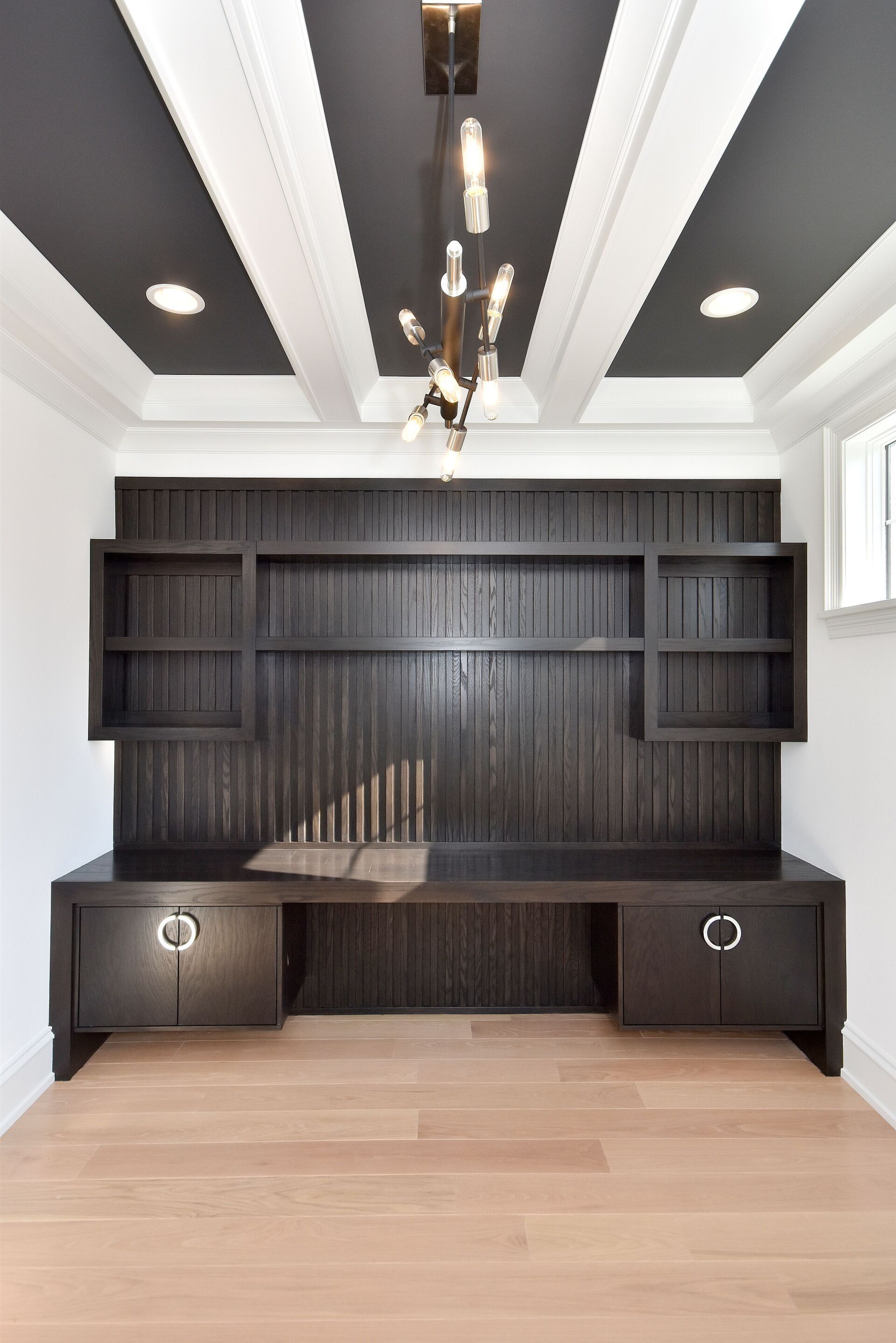 A room with a black and white striped ceiling and a desk.