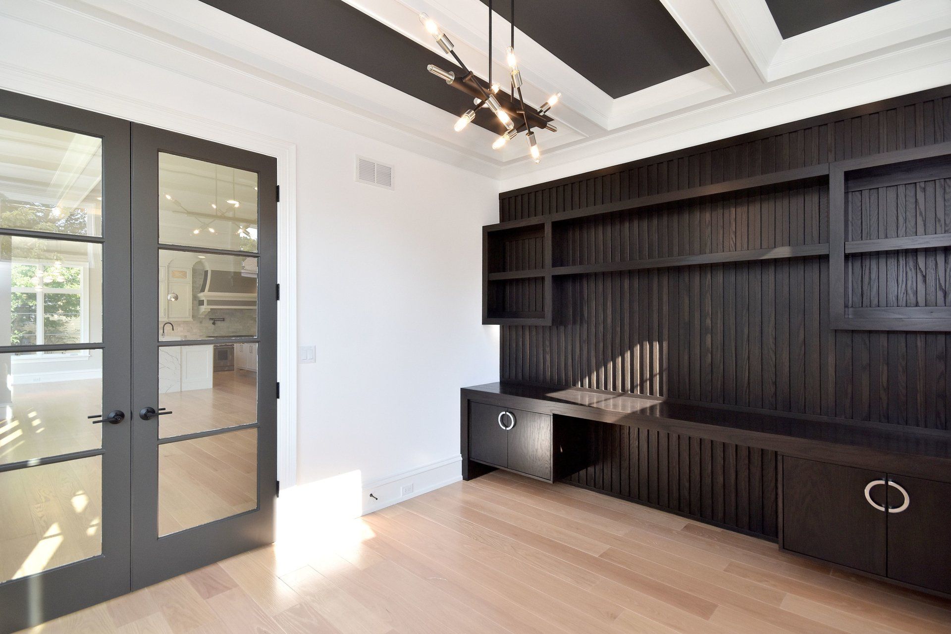 An empty room with a desk and shelves in it