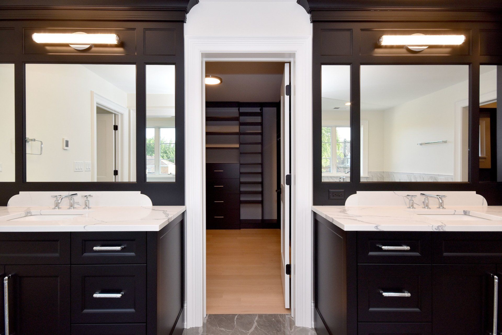 A bathroom with two sinks and two mirrors