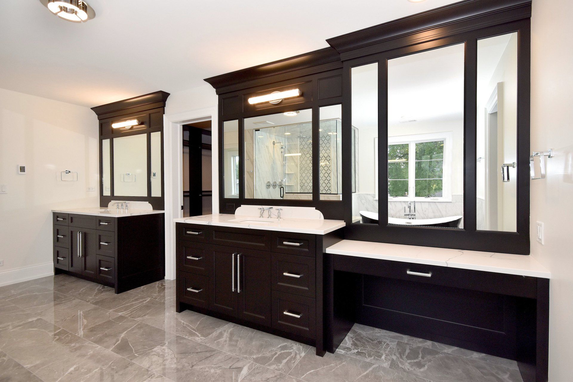 A bathroom with two sinks and two mirrors