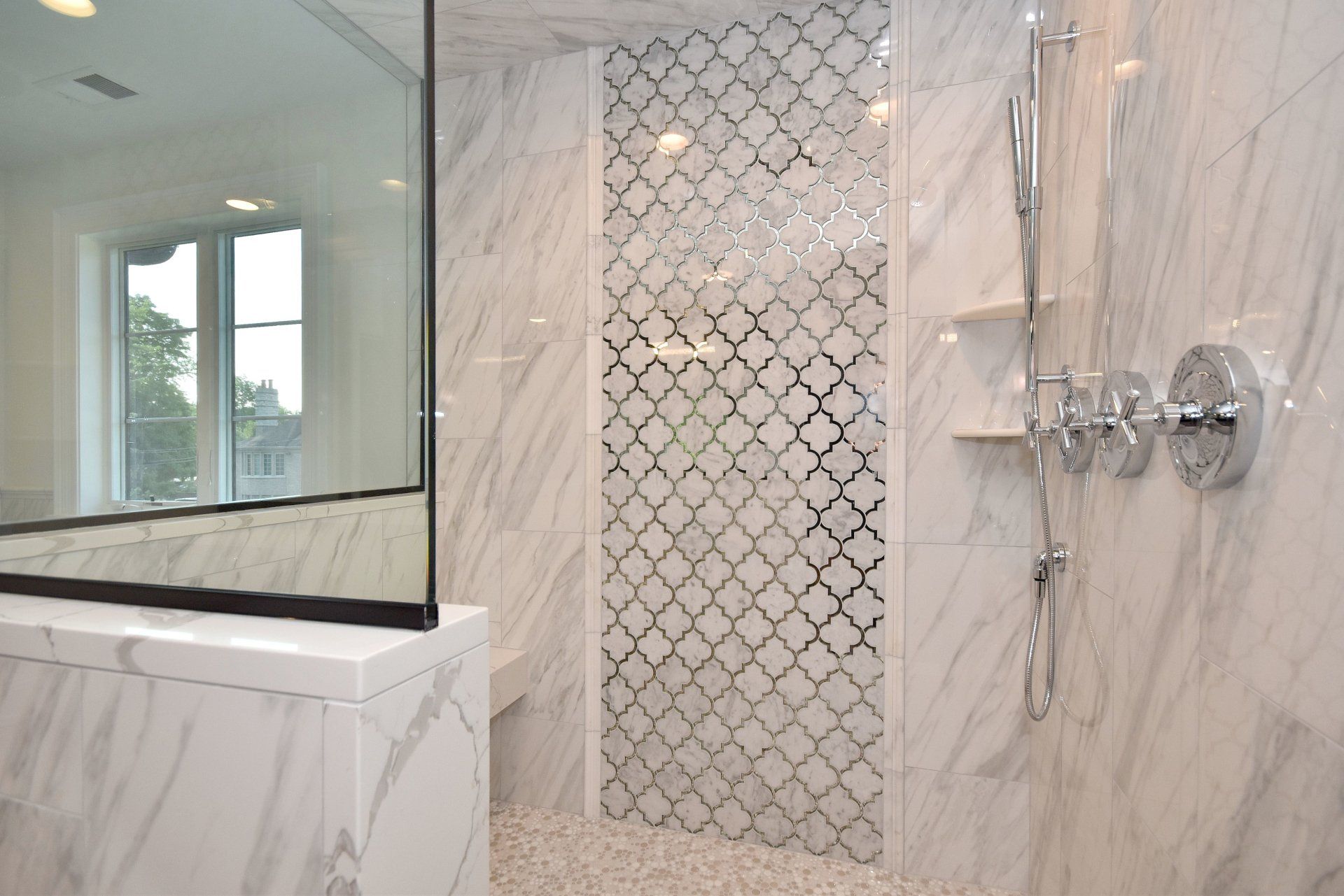A bathroom with a walk in shower and a mirror.