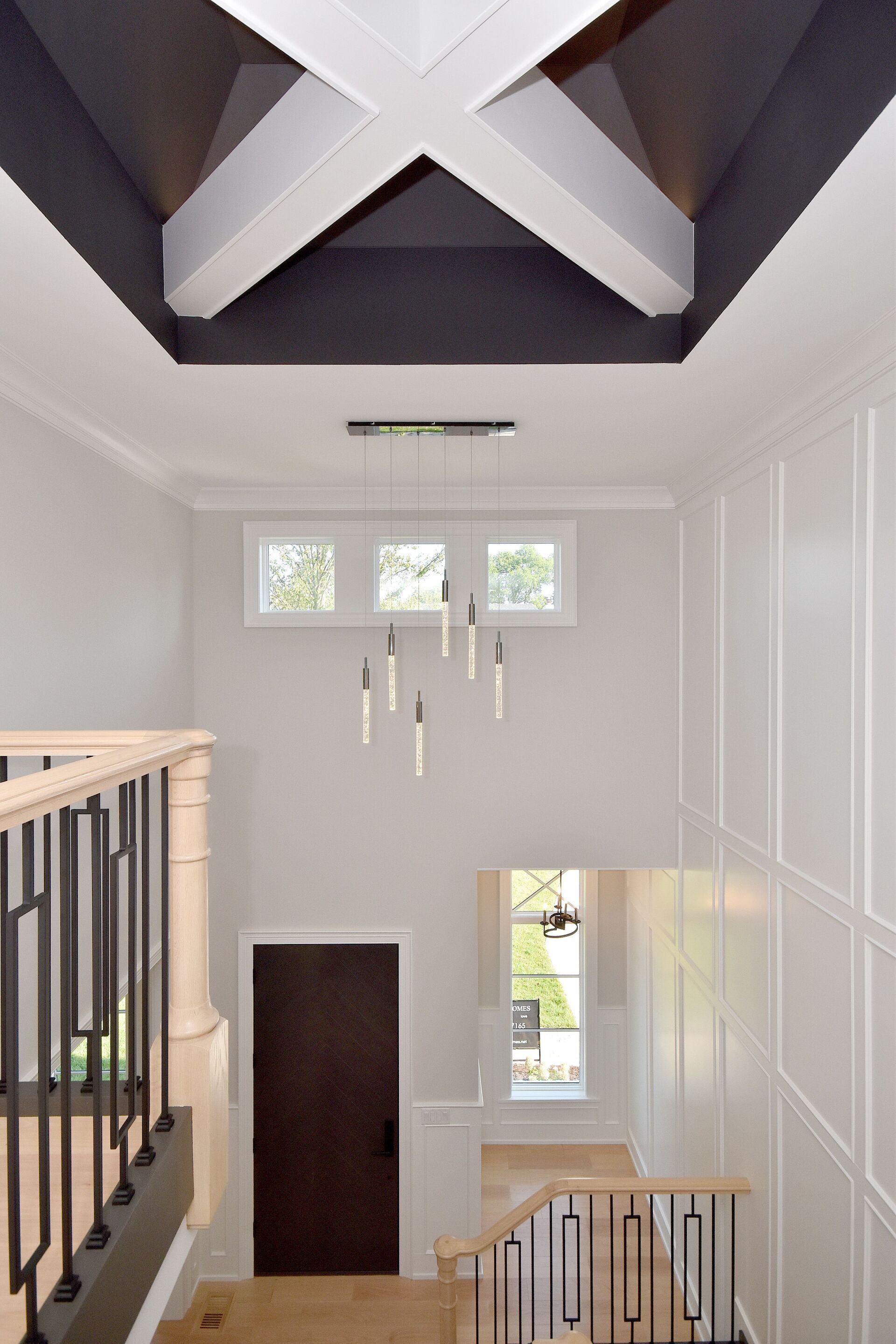 A hallway with a staircase leading up to the second floor