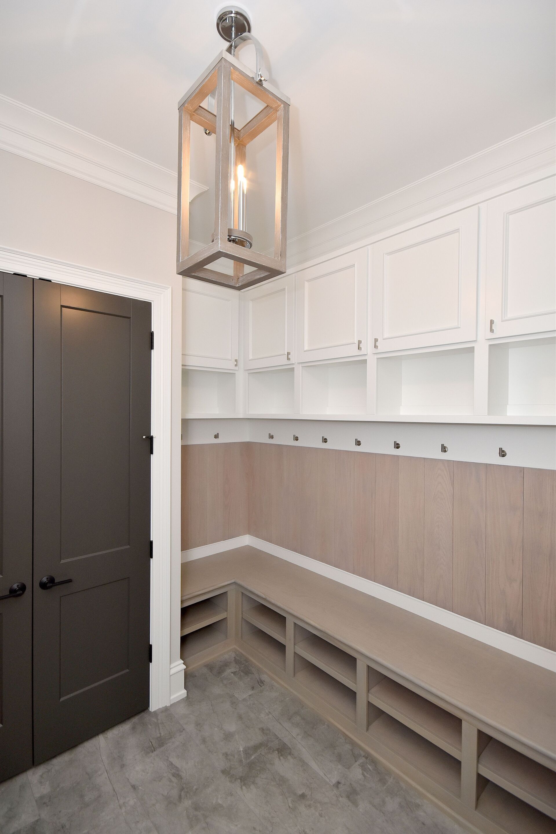 A room with a bench and a lantern hanging from the ceiling.