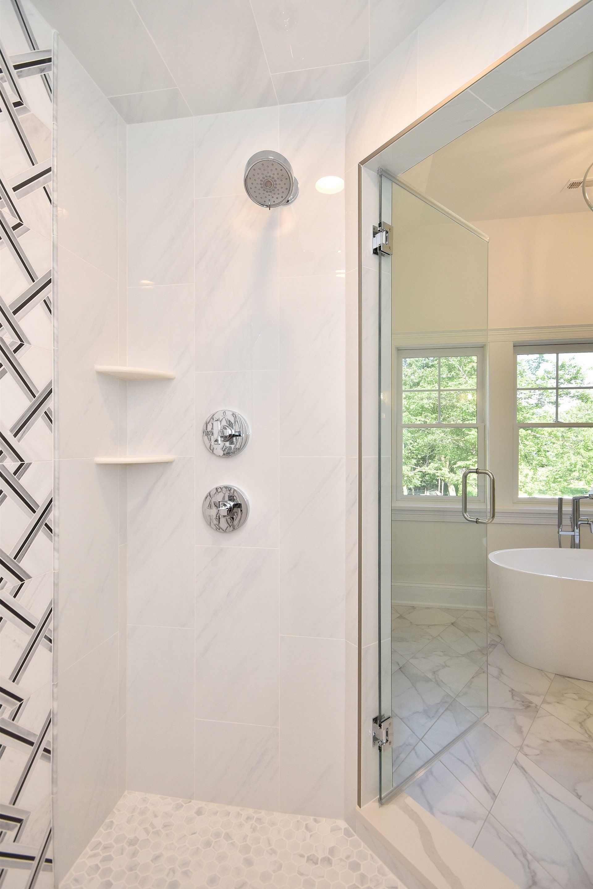A bathroom with a walk in shower and a bathtub.