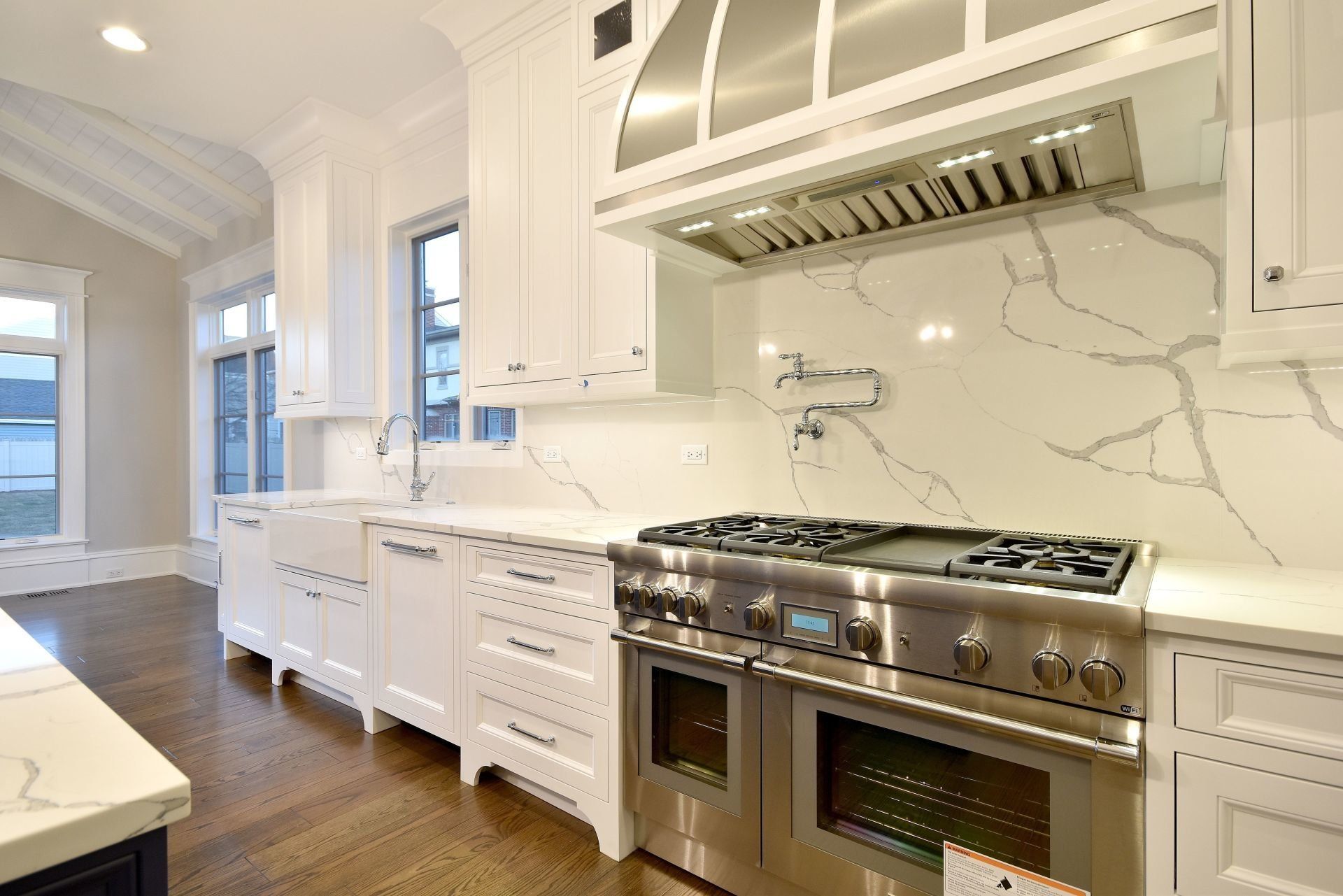A kitchen with stainless steel appliances and white cabinets.