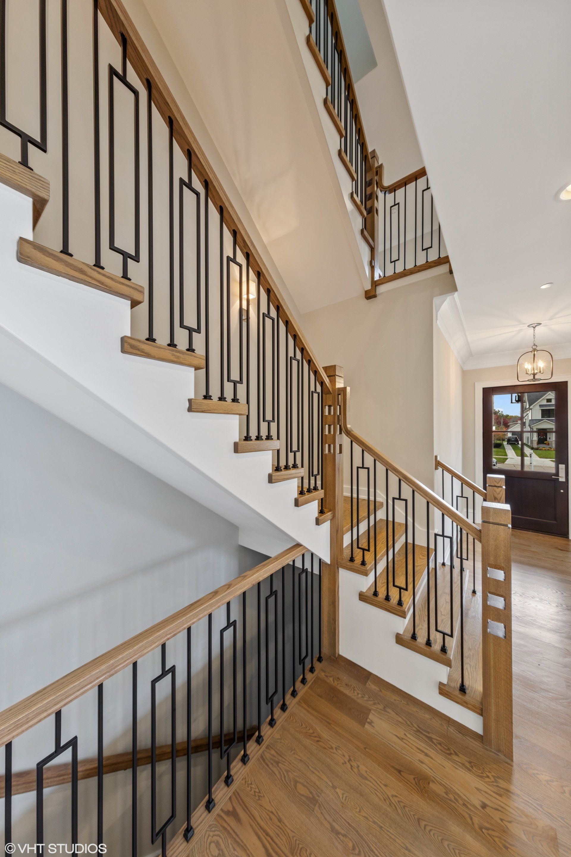 A staircase with wooden steps and a metal railing in a house.