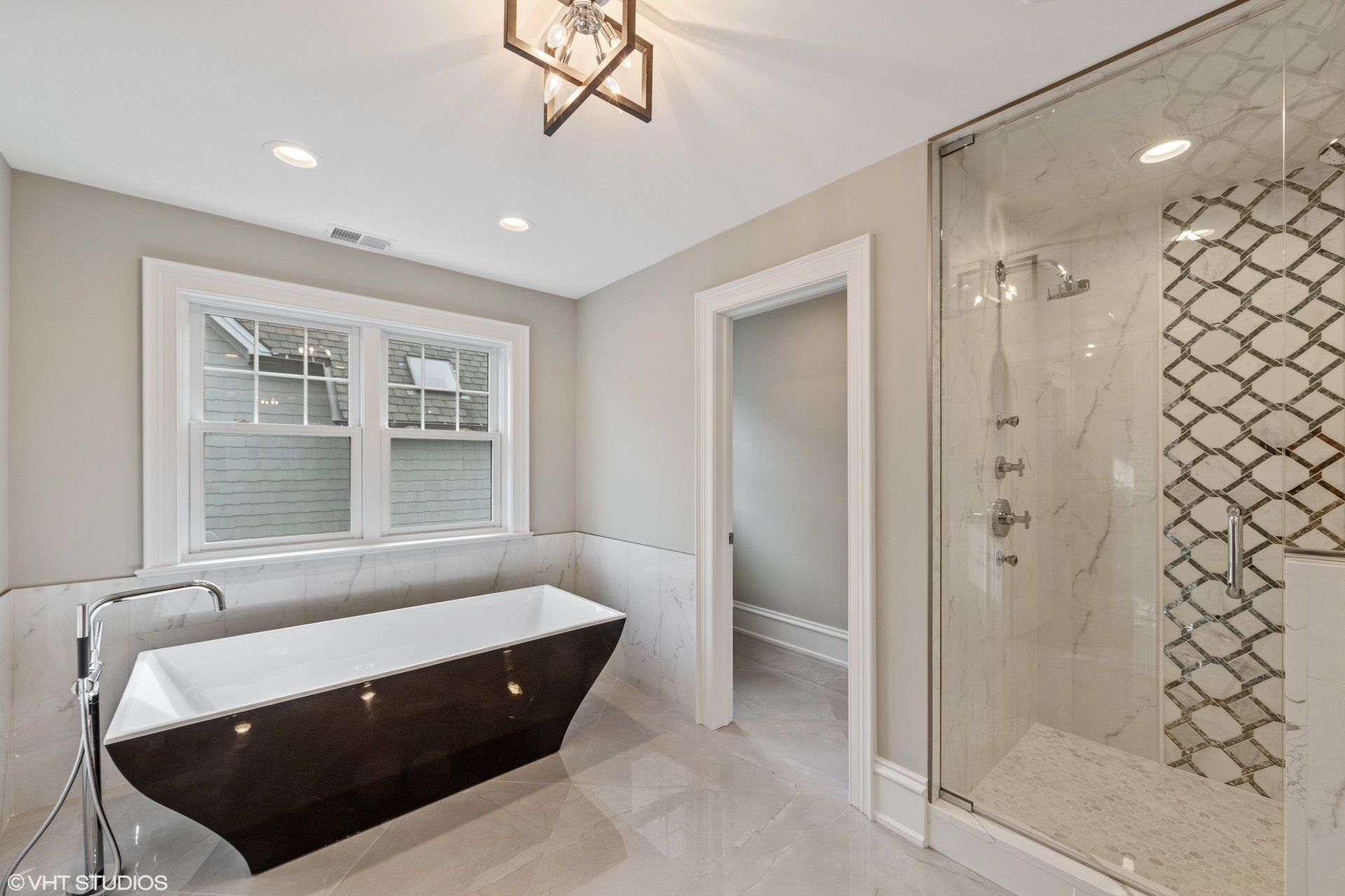 A bathroom with a bathtub and a walk in shower.