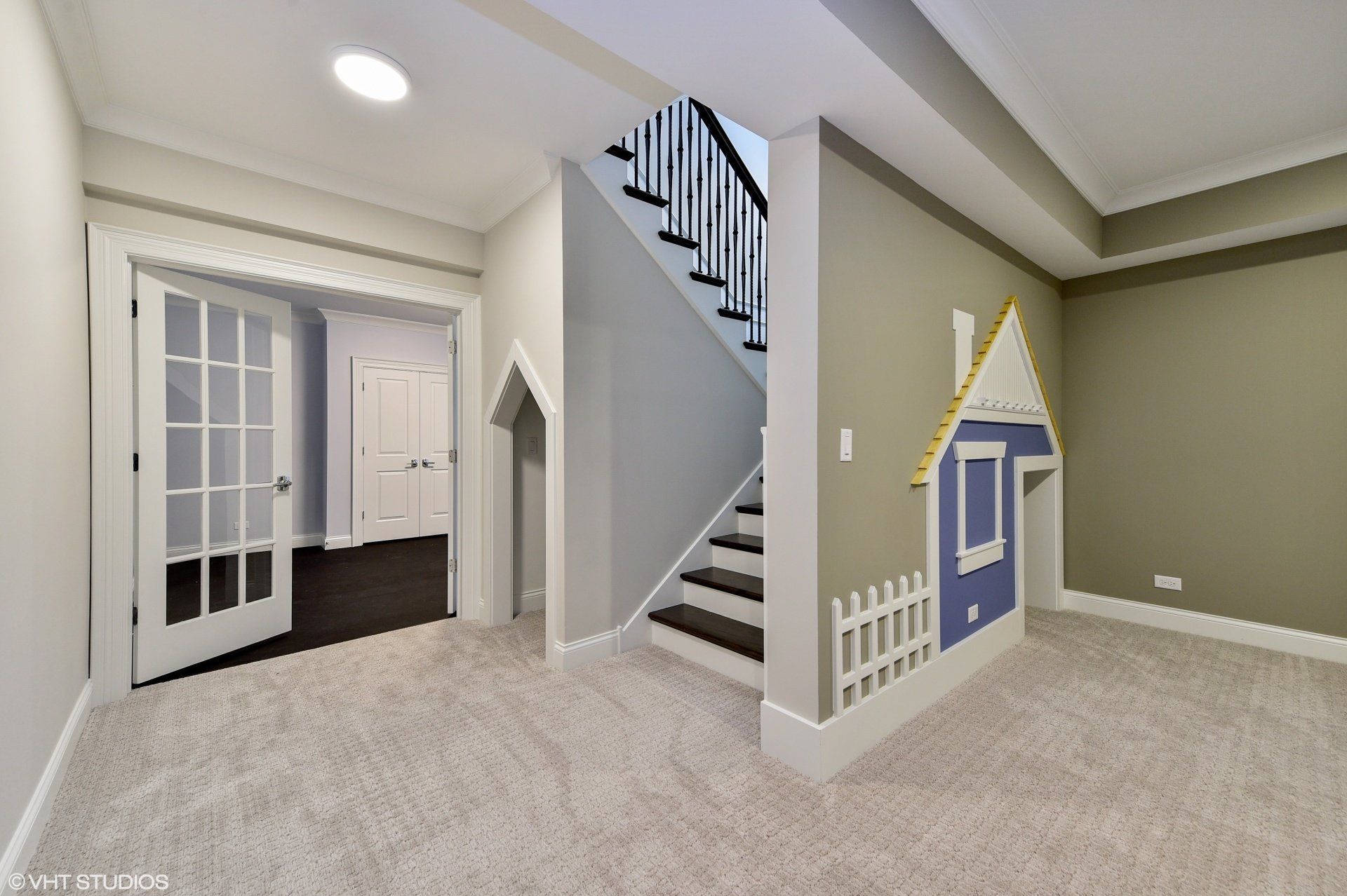 A basement with stairs and a house painted on the wall