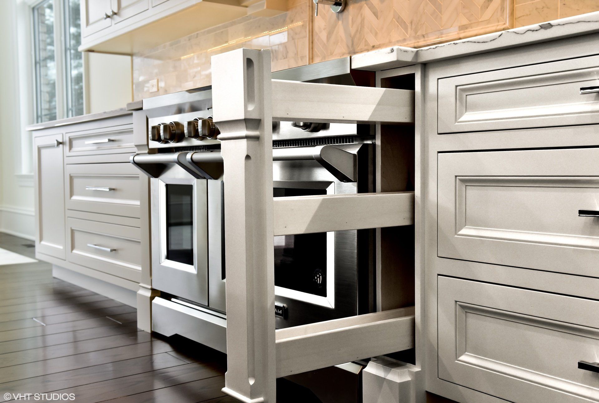 A kitchen with stainless steel appliances and white cabinets