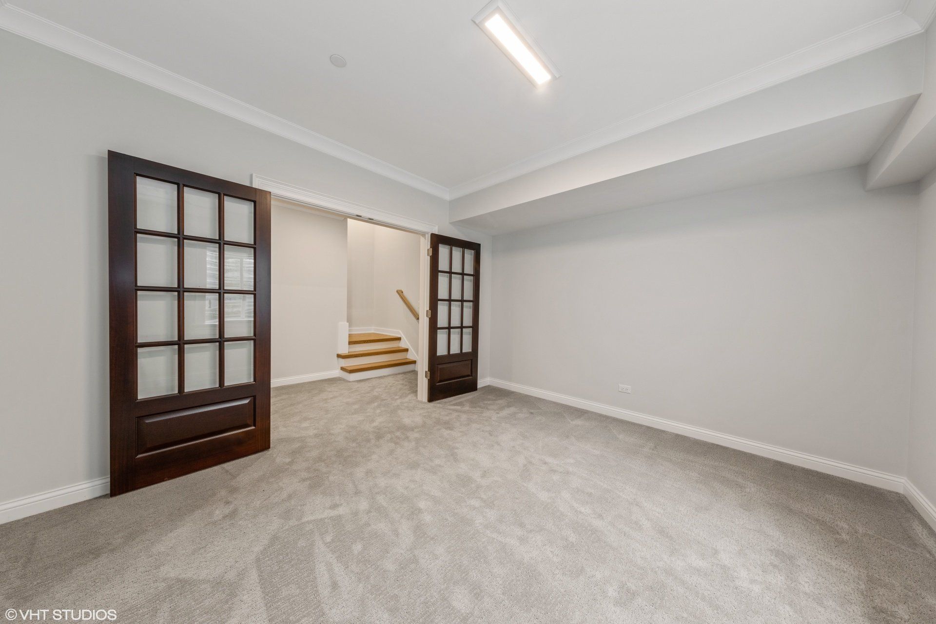 An empty room with a staircase leading to the second floor.