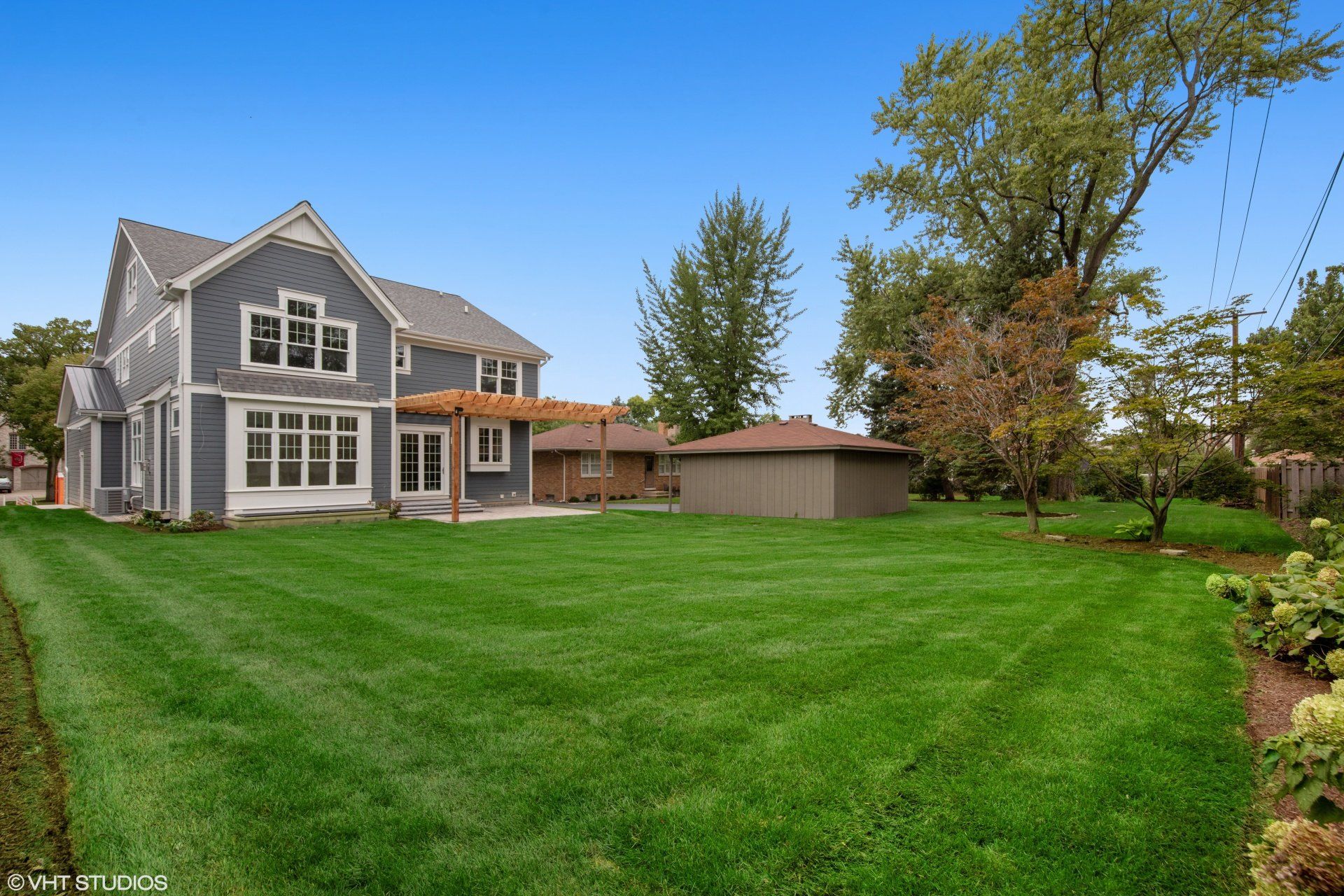 A large house with a large lawn in front of it.