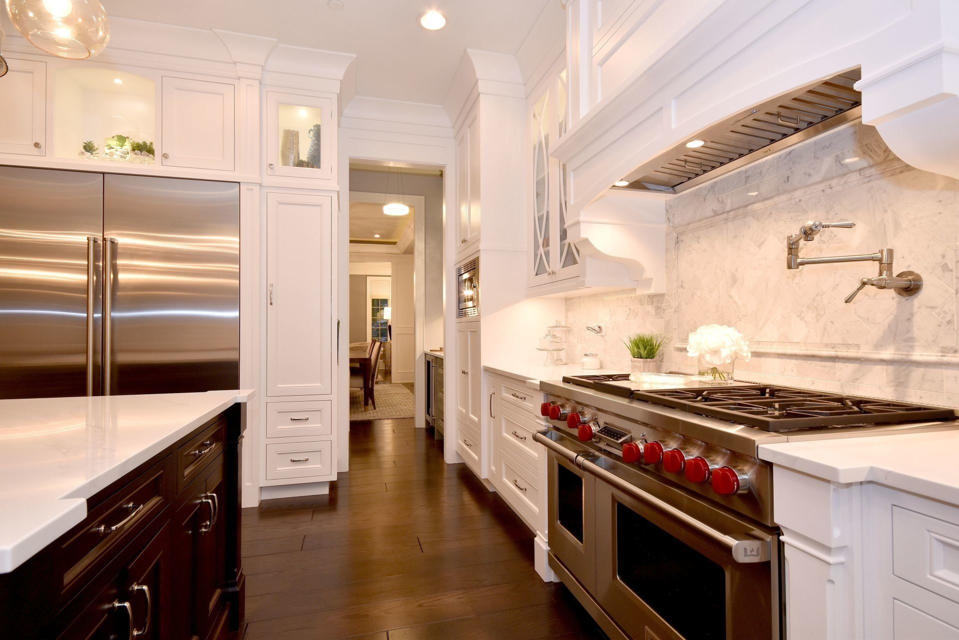 A kitchen with stainless steel appliances and white cabinets