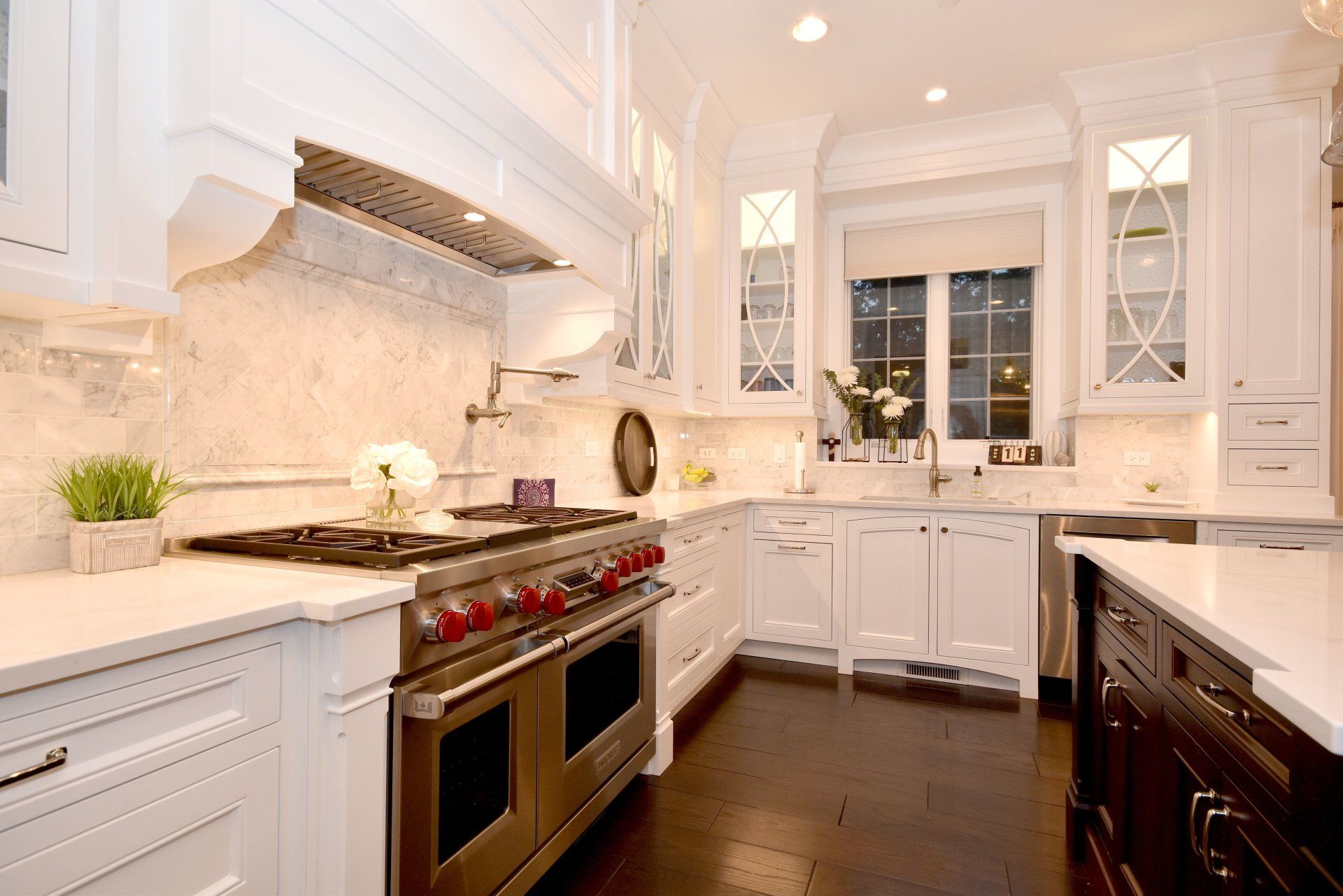 A kitchen with white cabinets and stainless steel appliances.