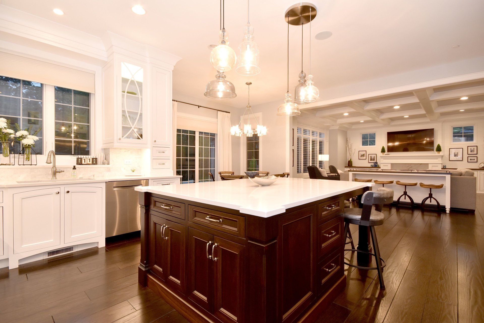 A kitchen with a large island and white counter tops
