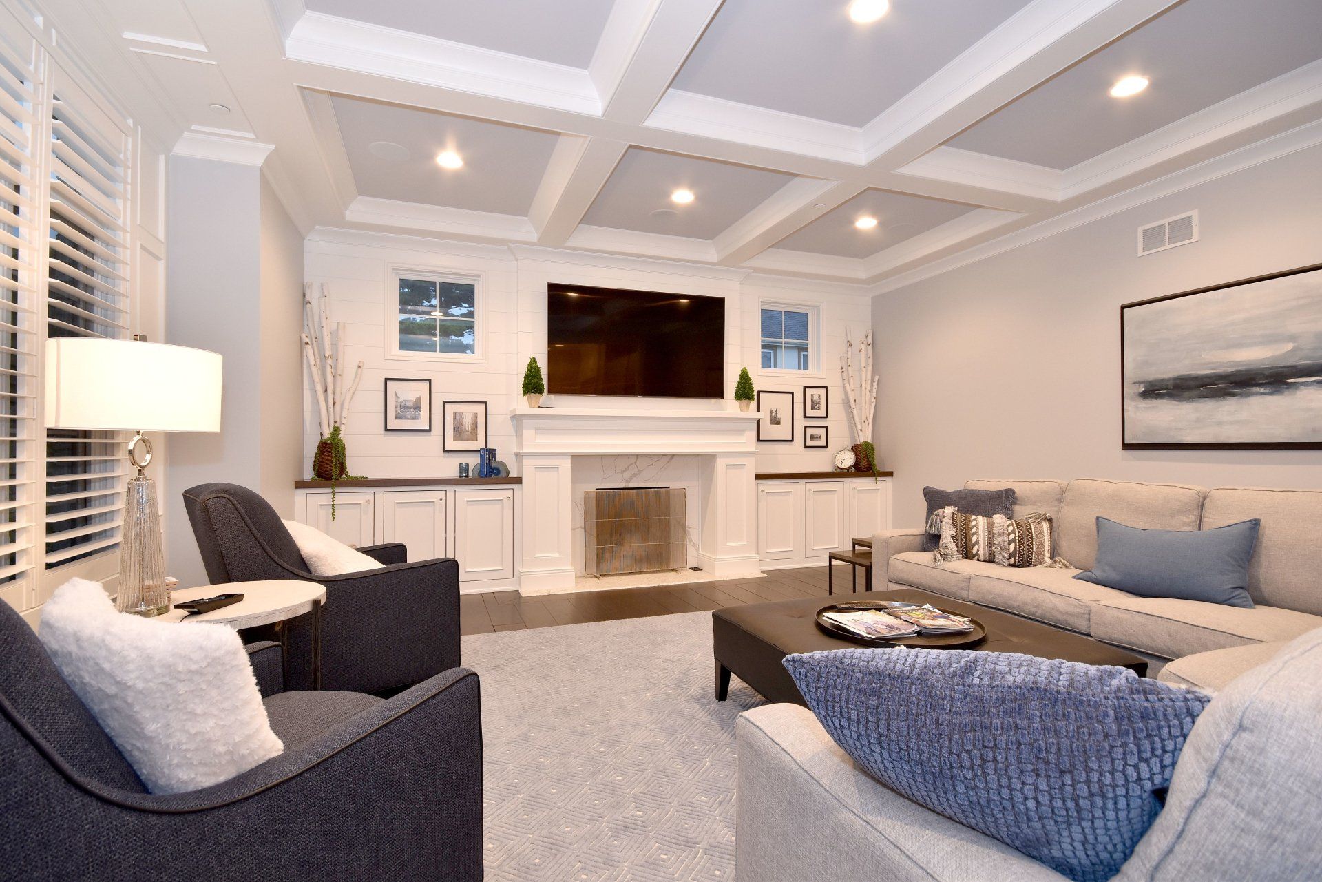 A living room with a fireplace , couch , chair and television.