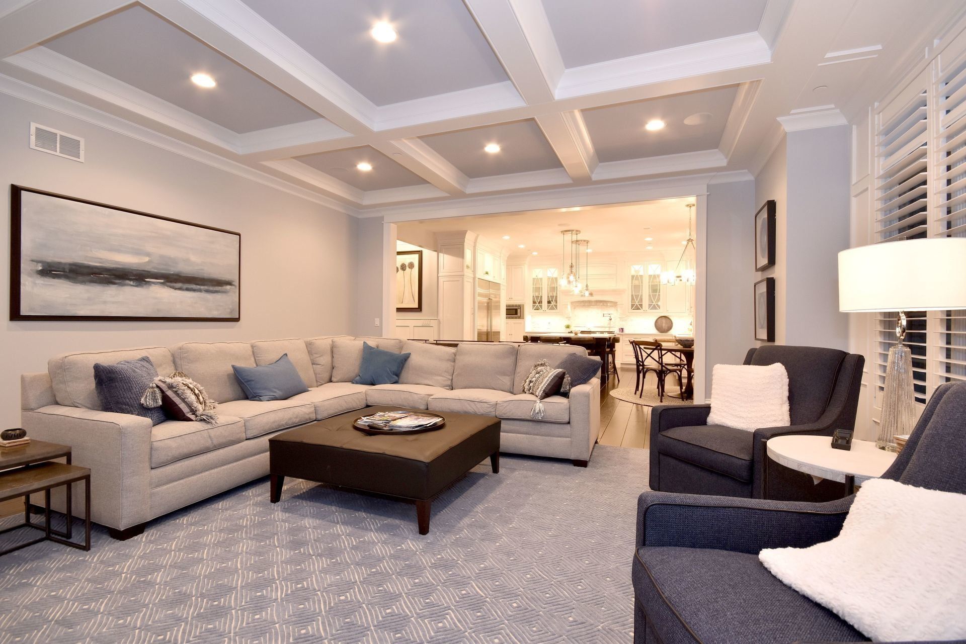 A living room with a large sectional couch and a coffee table