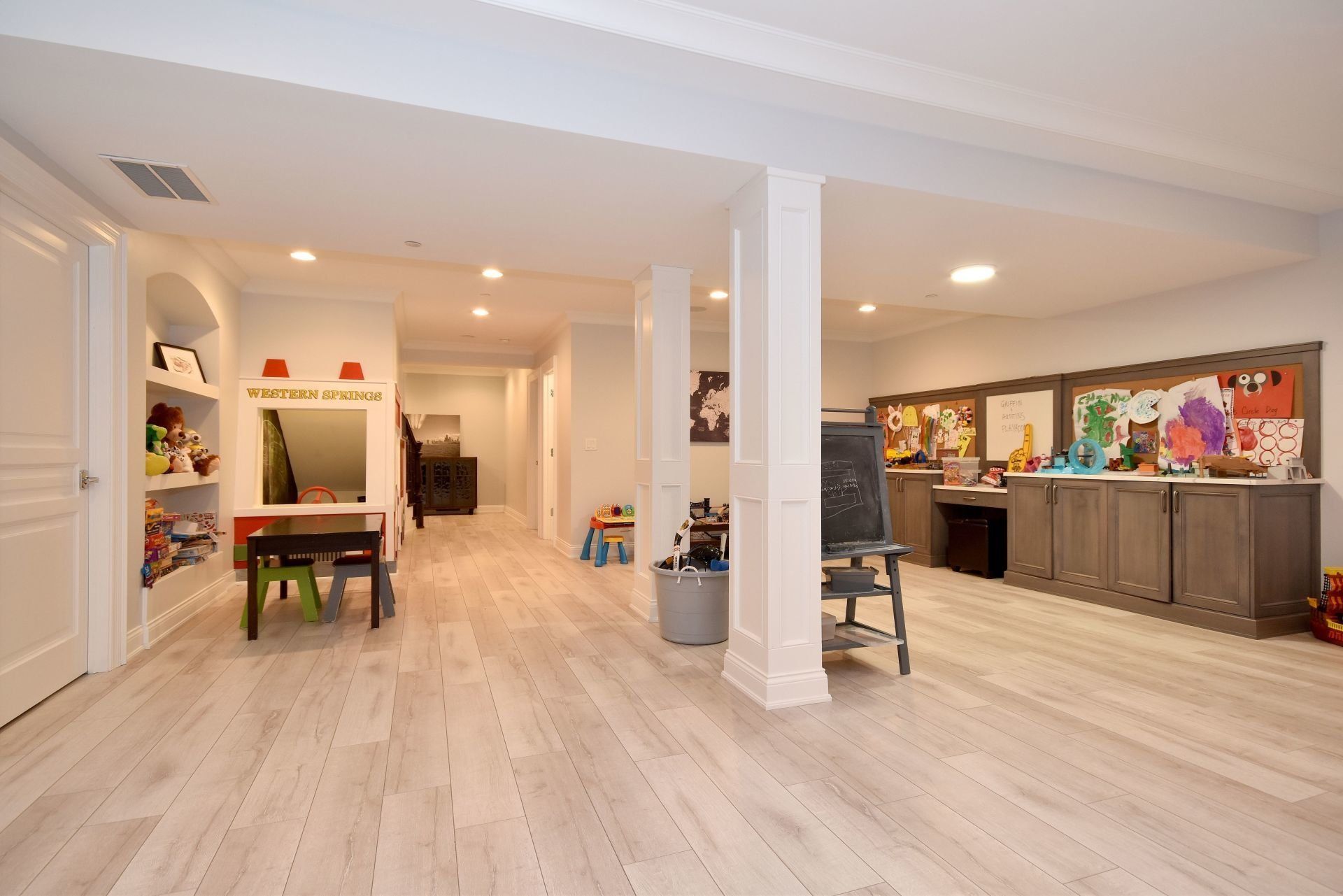 A large room with a table and chairs in it.