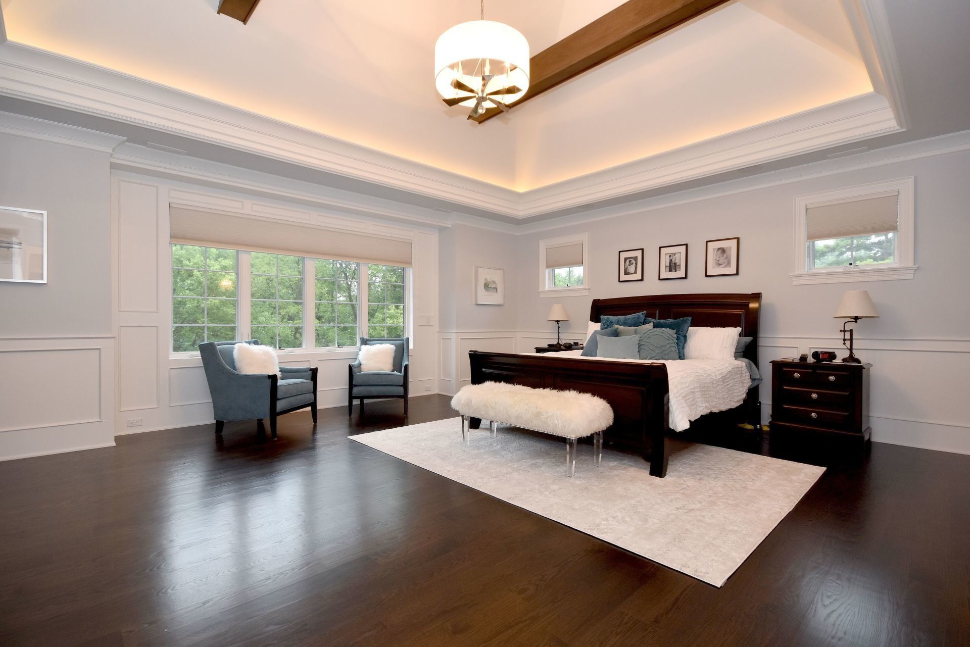 A large bedroom with a large bed and chairs