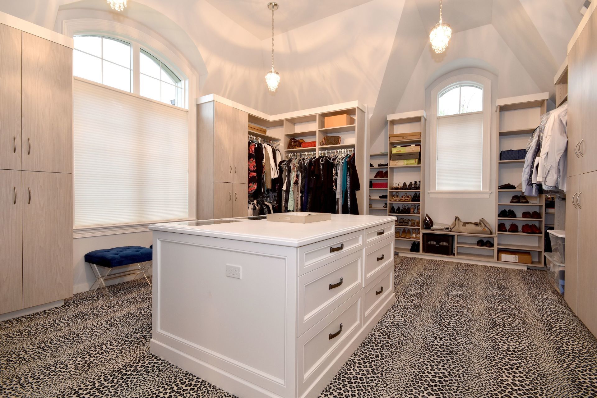 A large walk in closet with a large island in the middle