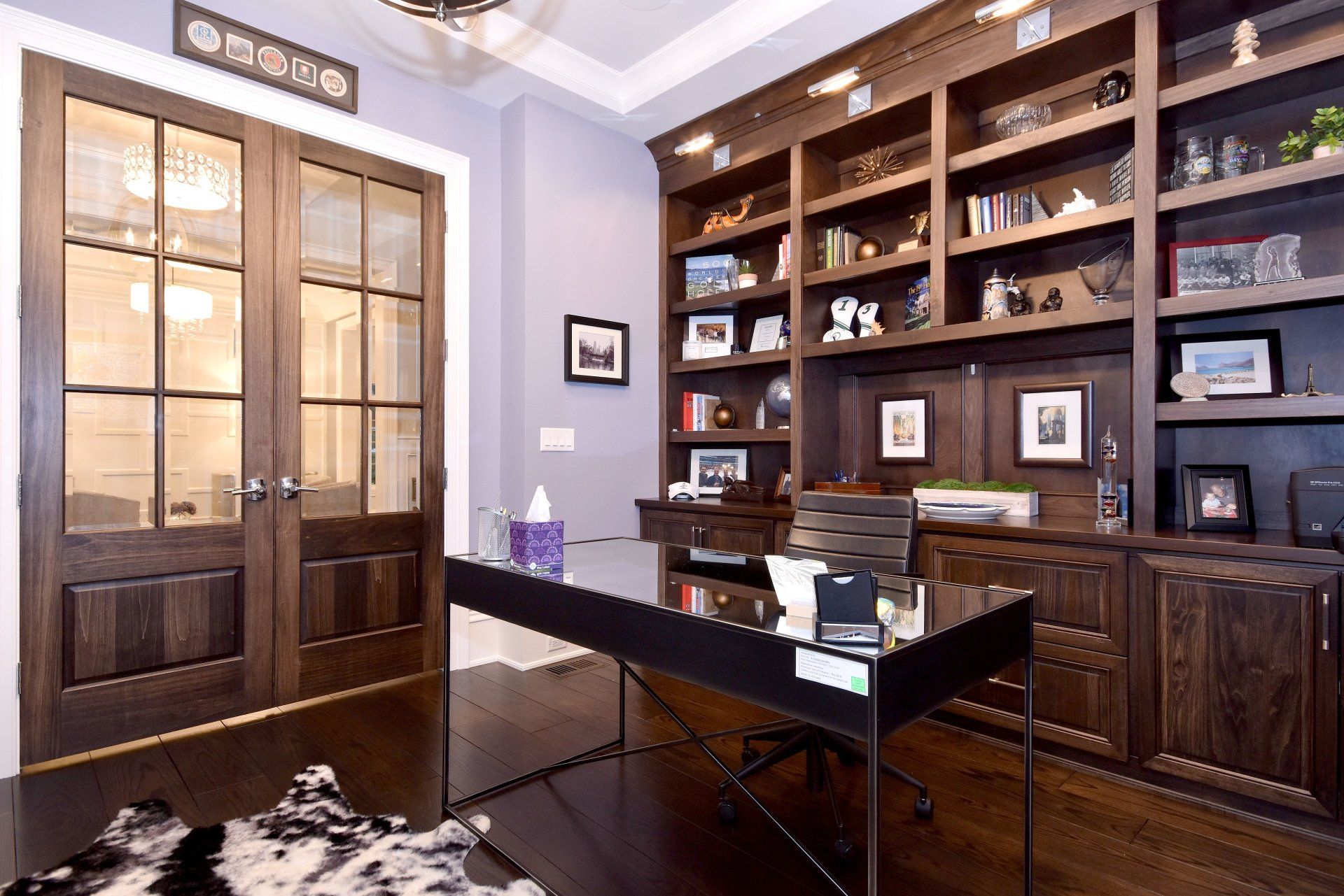 A home office with a desk and lots of shelves