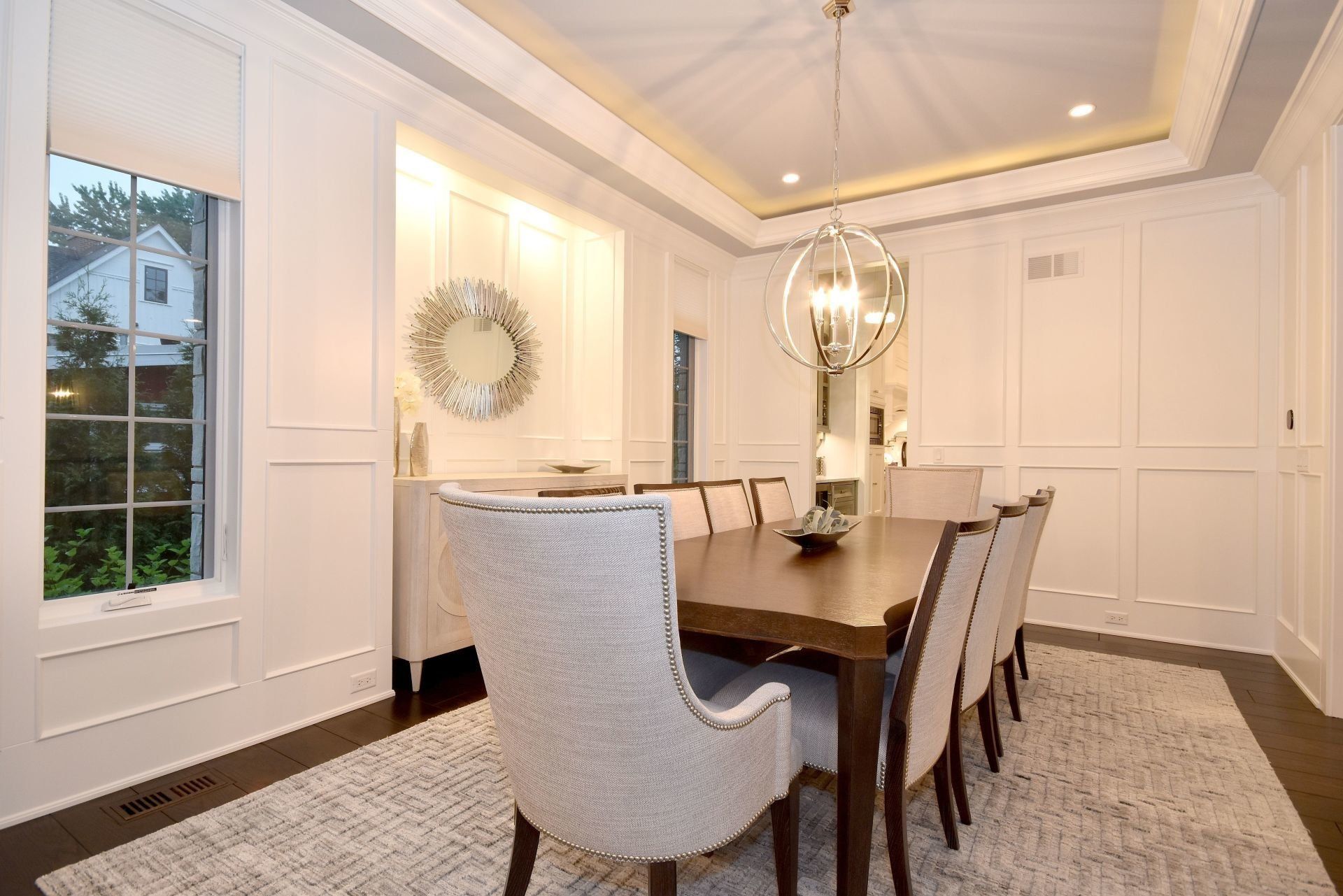 A dining room with a long table and chairs