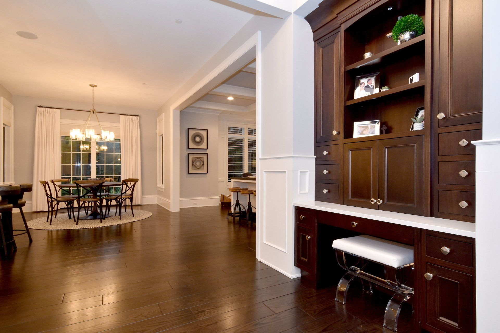 A dining room with a table and chairs and a desk