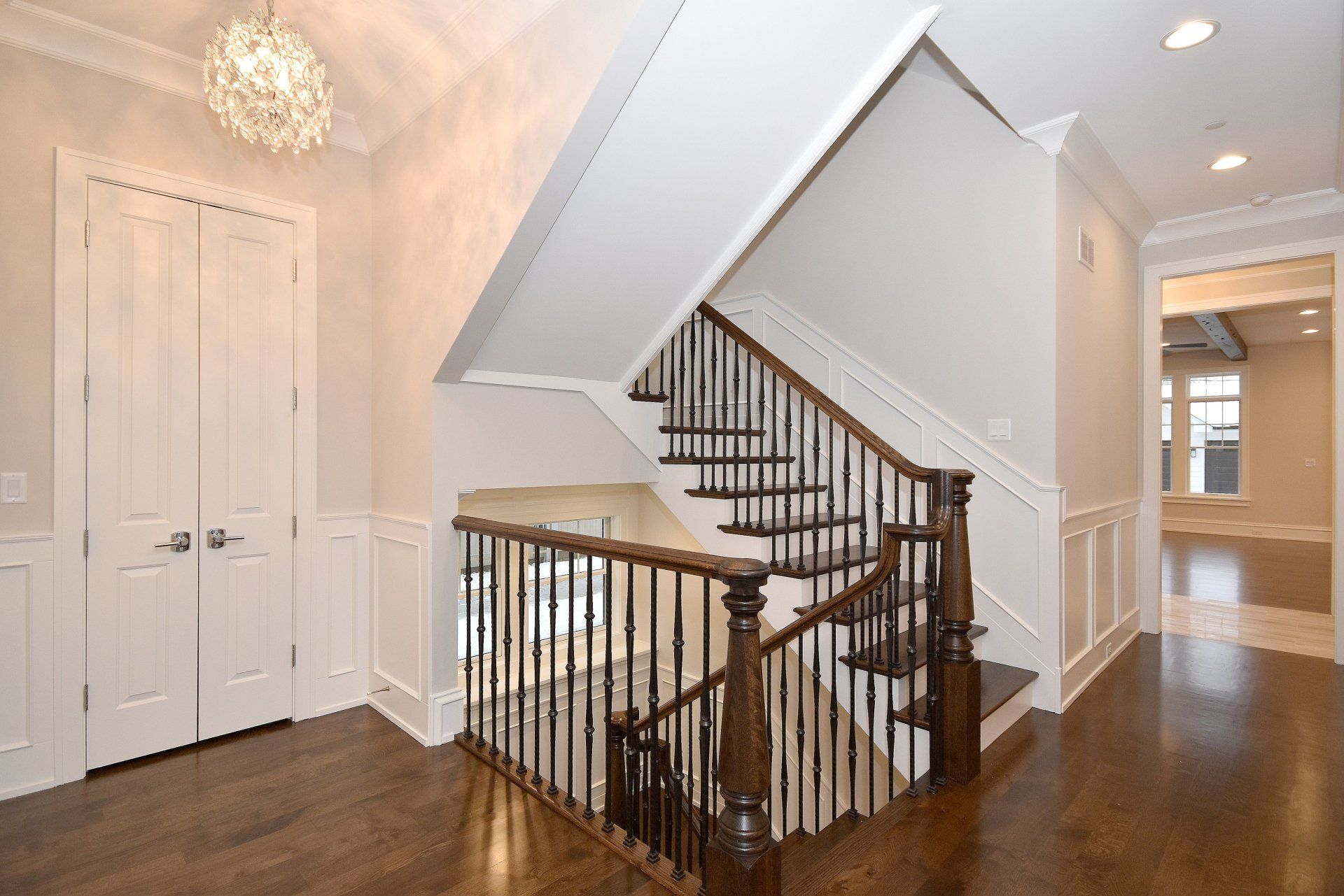 A hallway with stairs leading up to the second floor