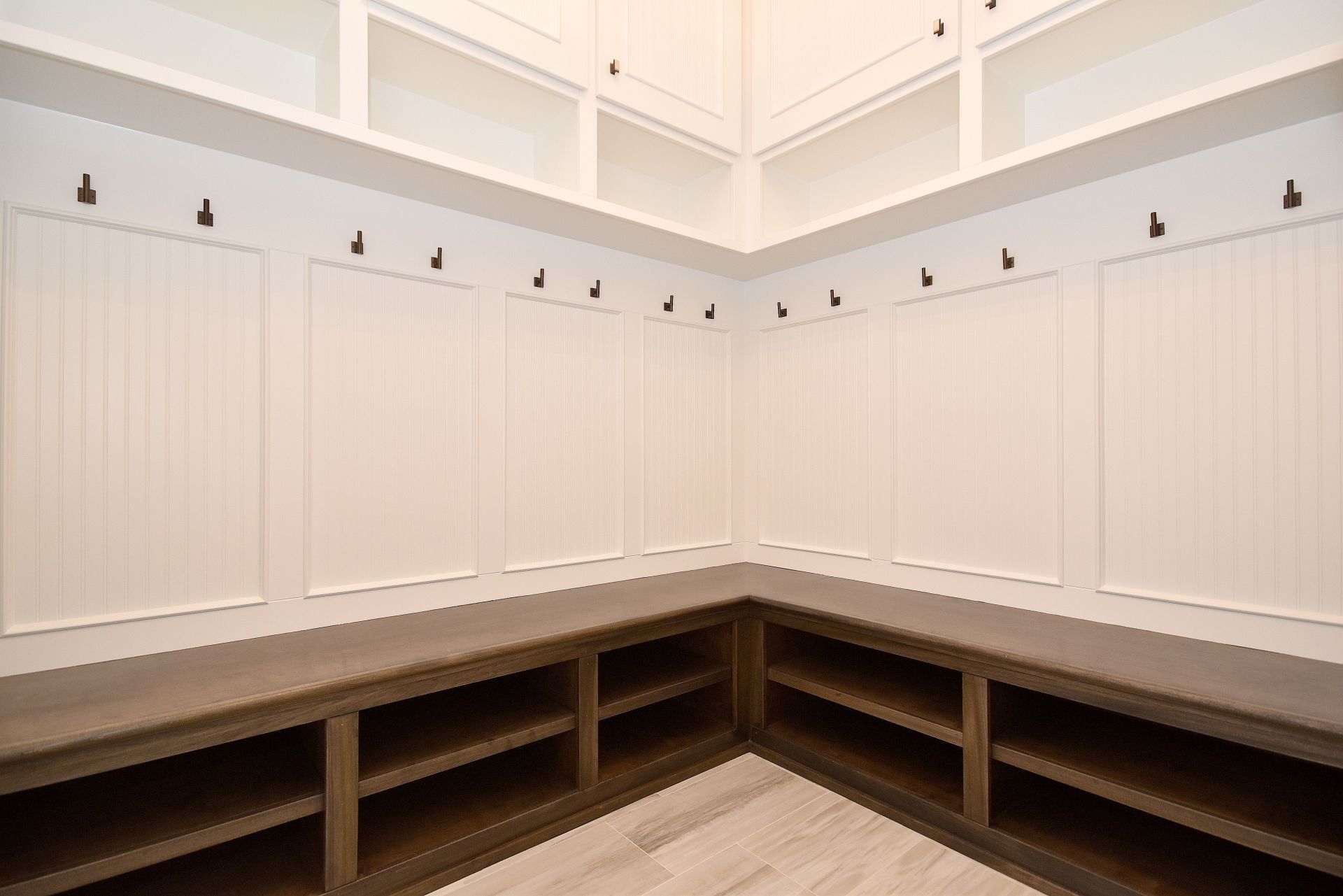 A room with a lot of shelves and hooks on the wall.