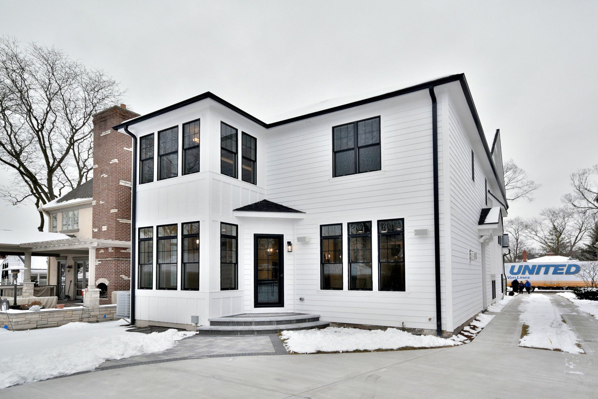 A united truck is parked in front of a white house