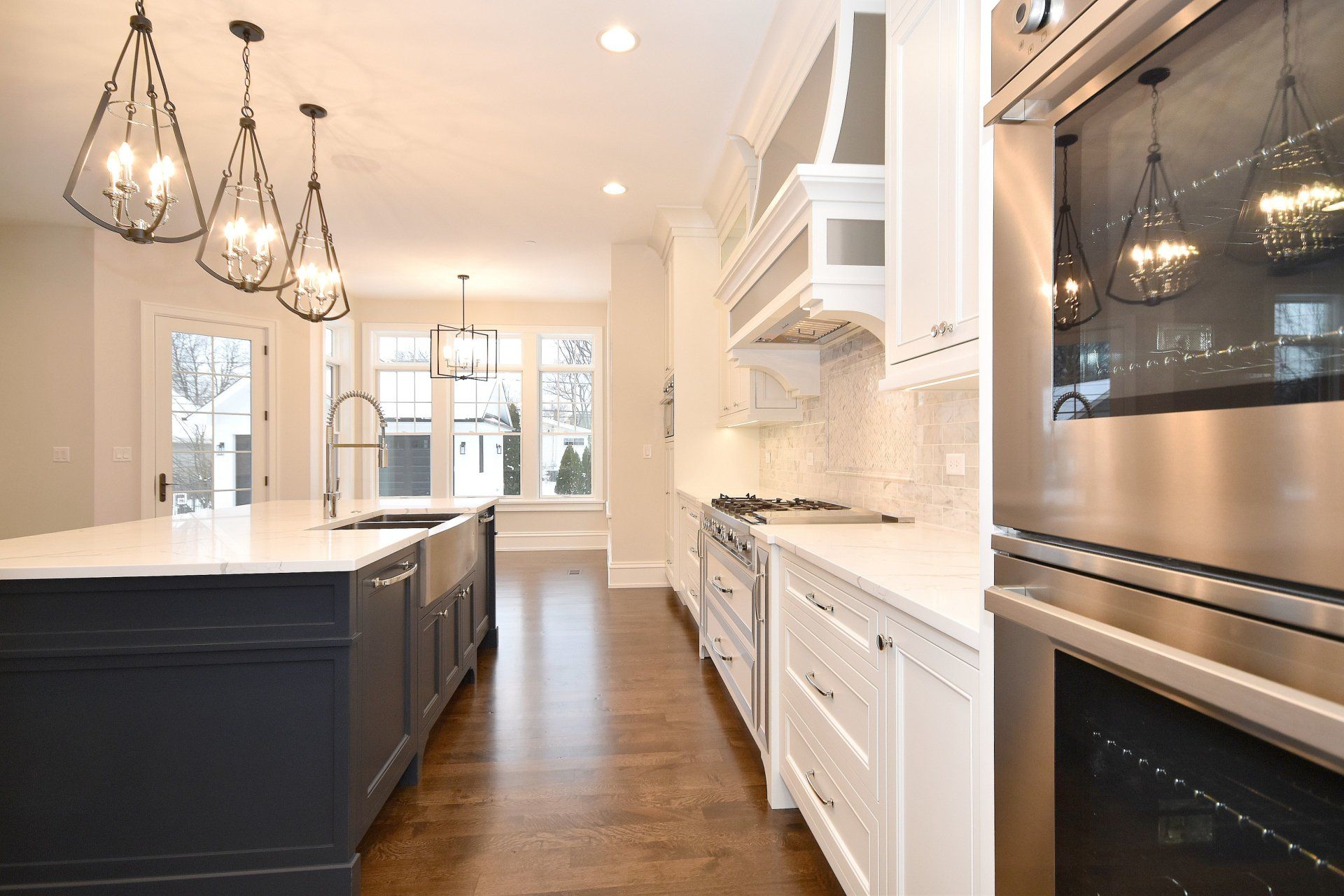 A kitchen with white cabinets and stainless steel appliances.