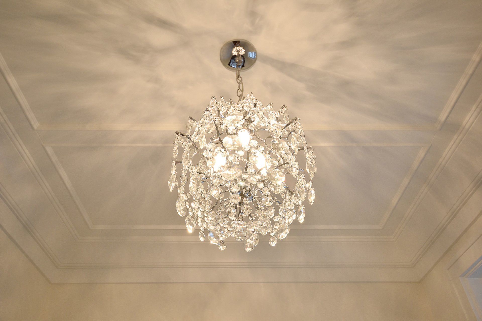 A chandelier is hanging from the ceiling in a room
