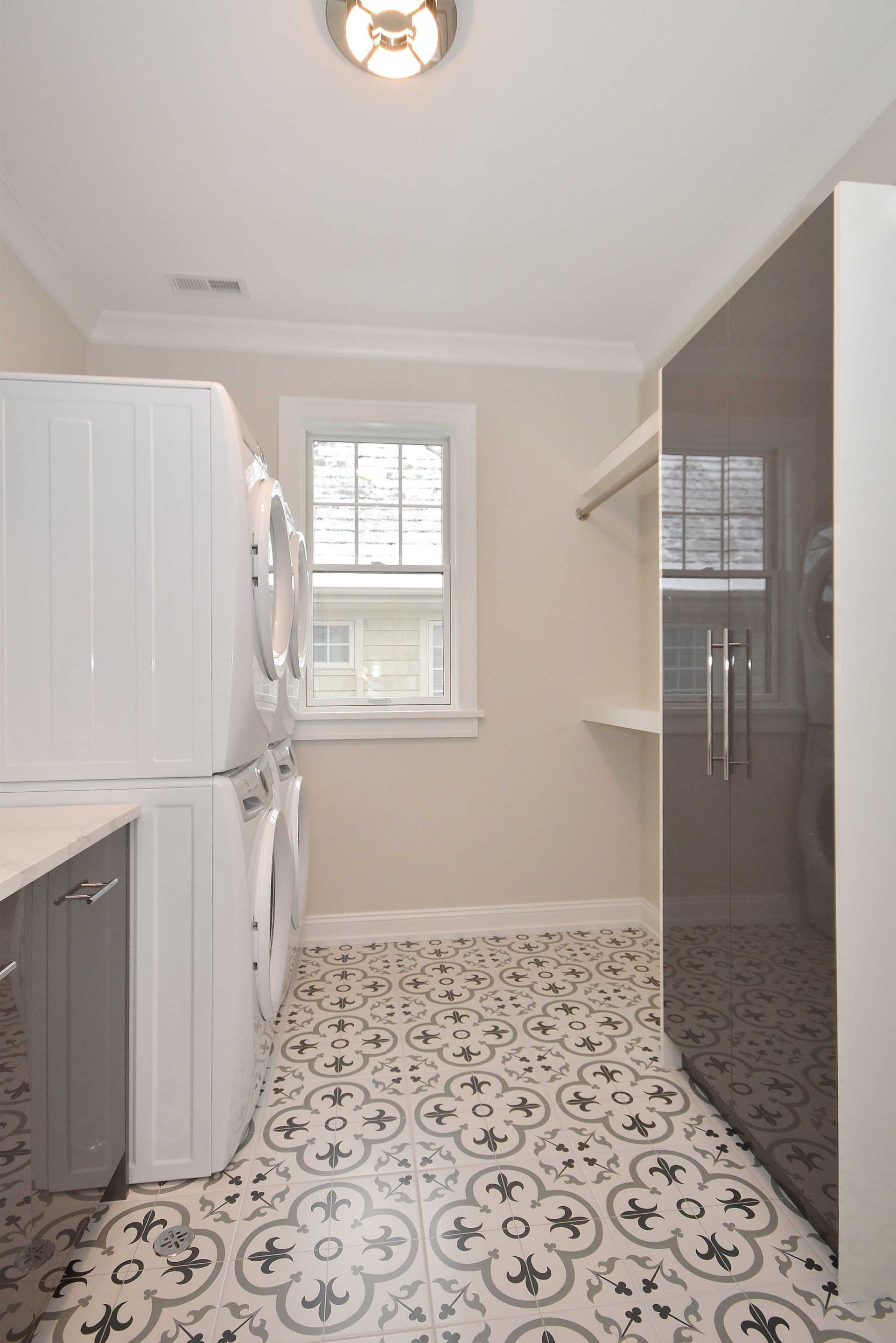 A laundry room with a washer and dryer and a window.