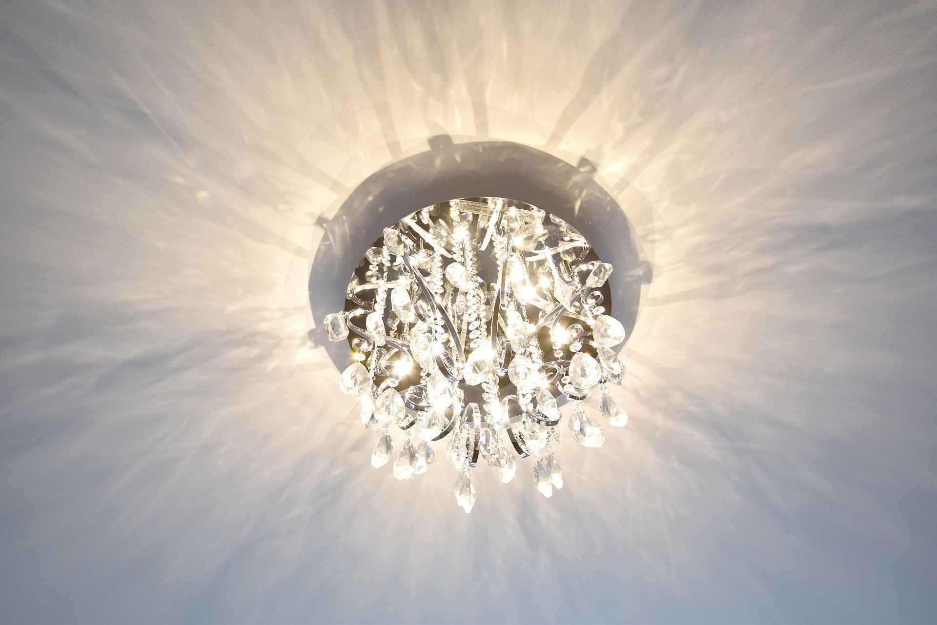 A chandelier is hanging from the ceiling and is lit up.