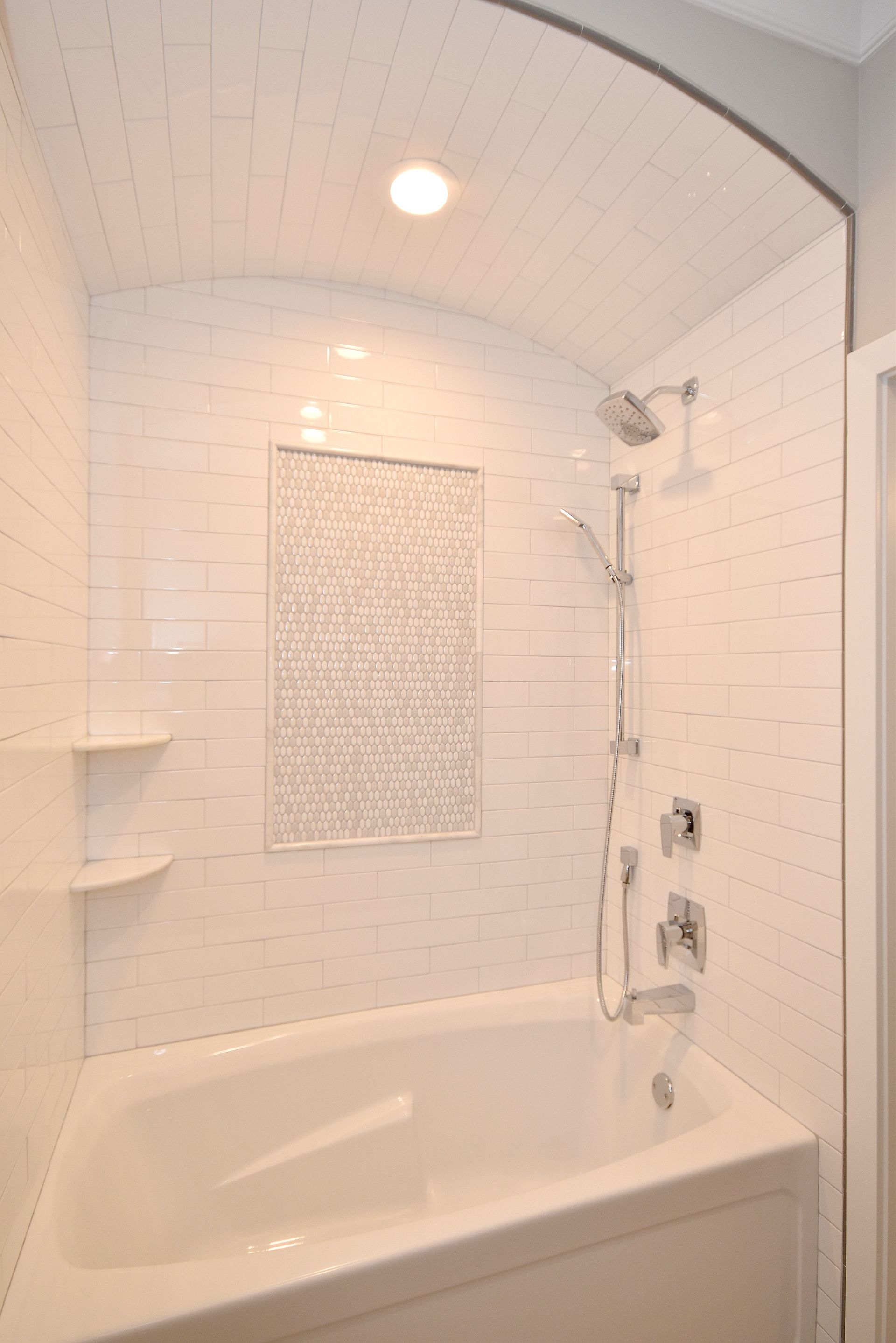 A bathroom with a bathtub and a shower.