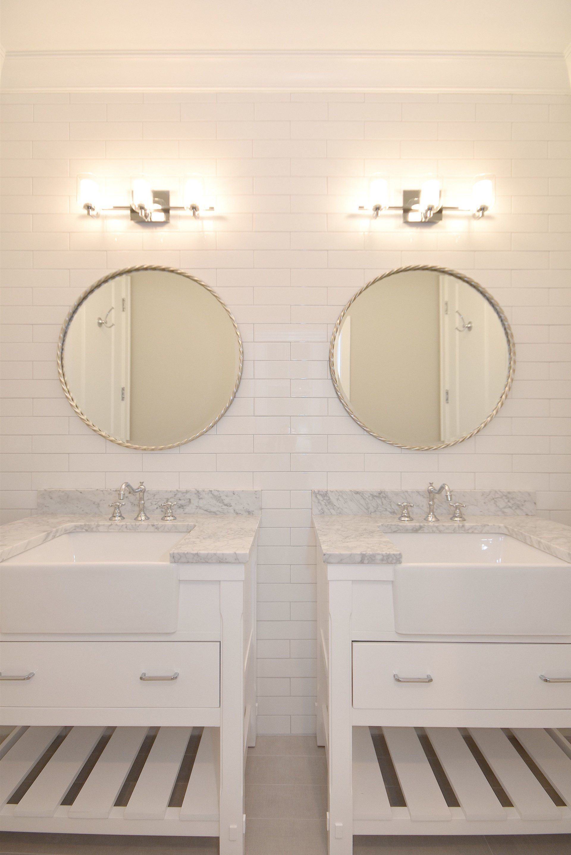 A bathroom with two sinks and two mirrors.