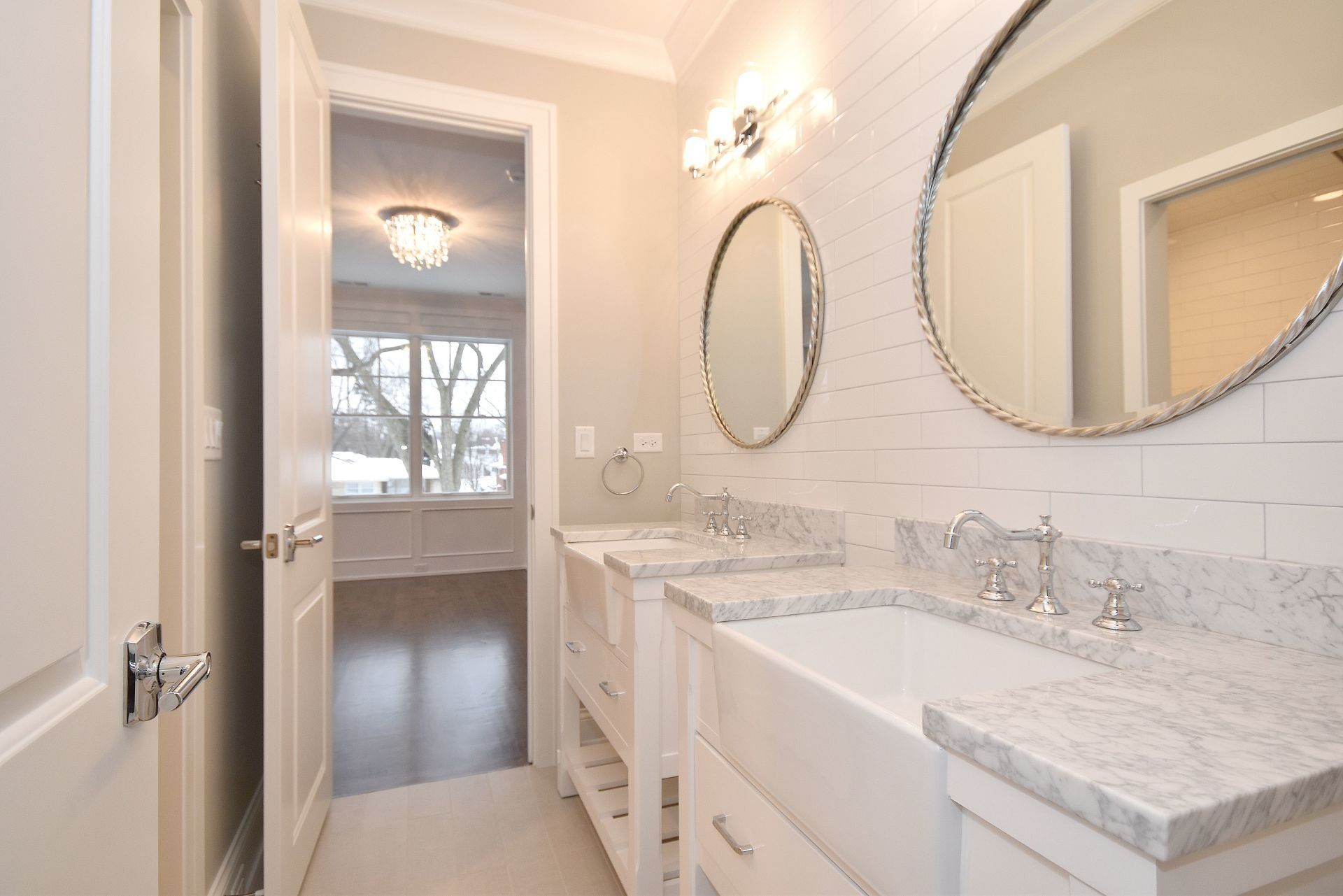 A bathroom with two sinks and two mirrors.