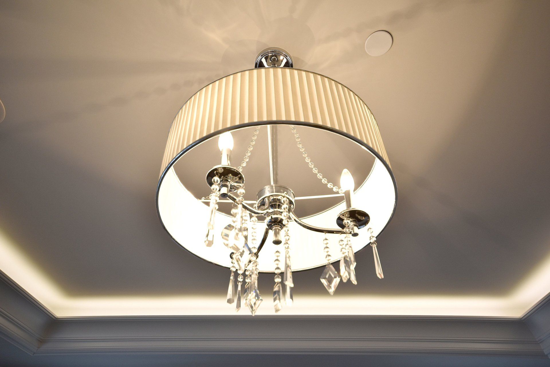 A chandelier is hanging from the ceiling in a room