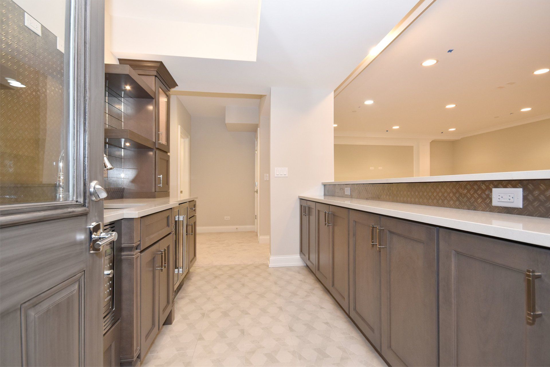 A kitchen with gray cabinets and white counter tops